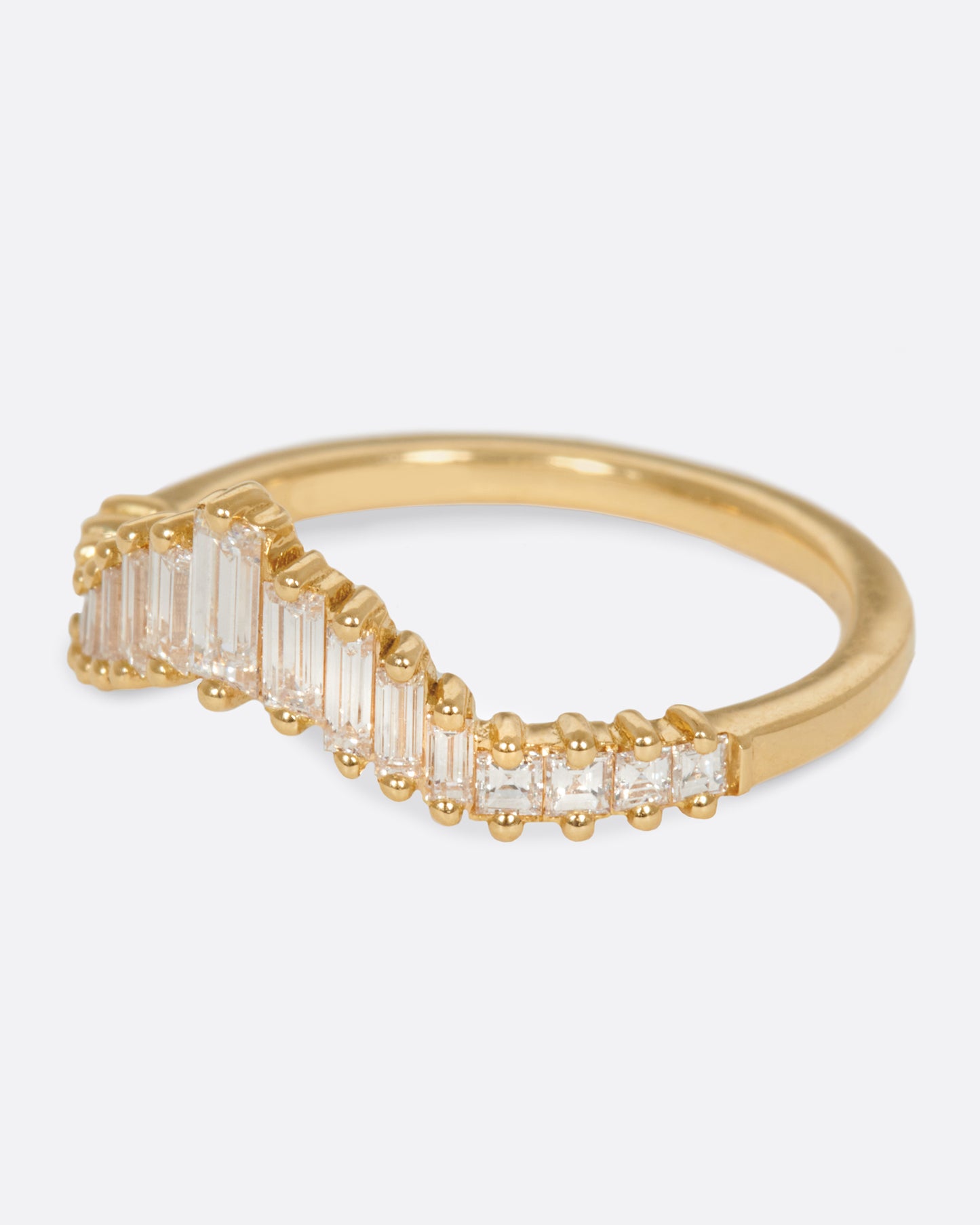 A curved crown ring lined with baguette diamonds.