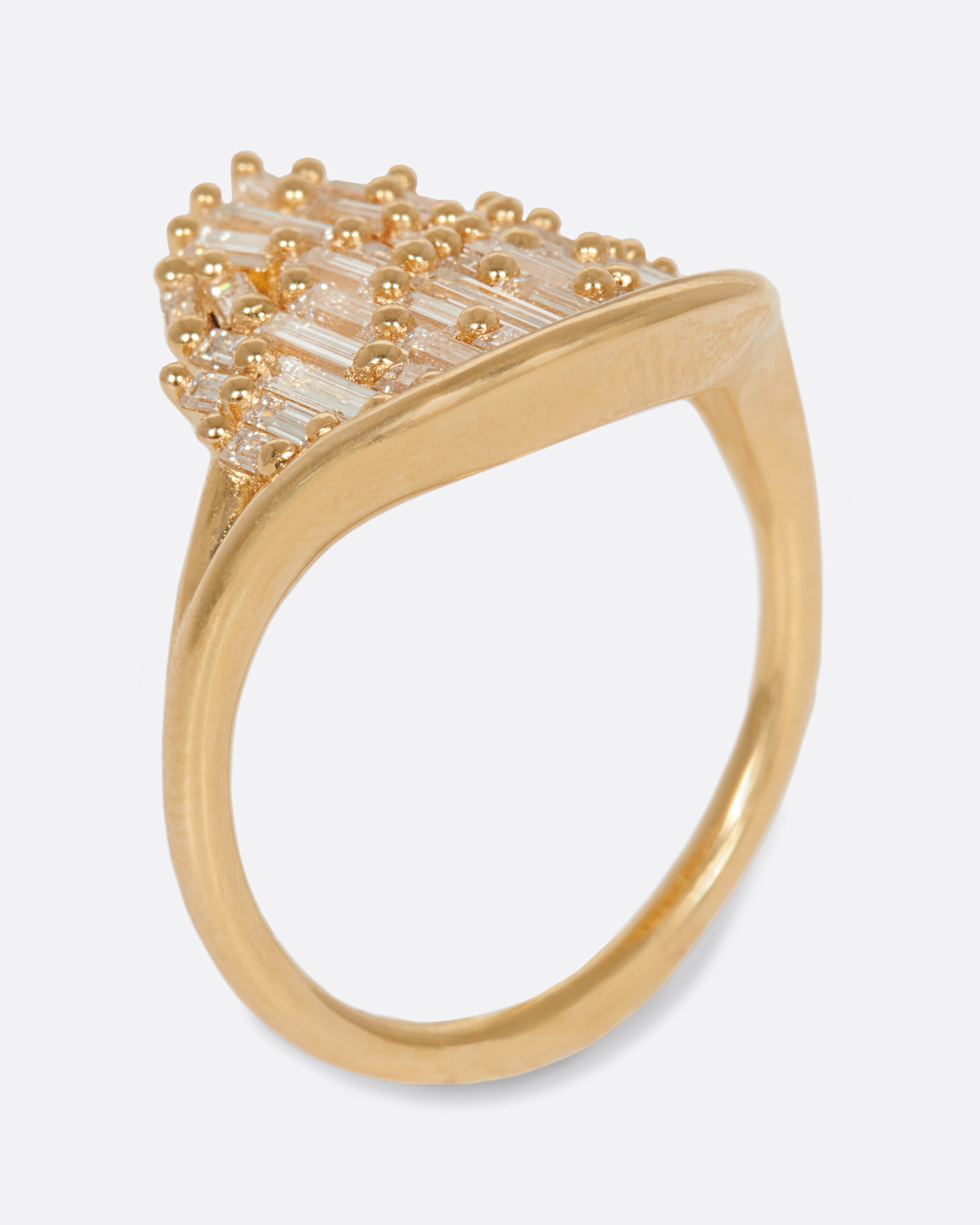 A semi-circular ring filled with diamond baguettes that grow slightly askew.