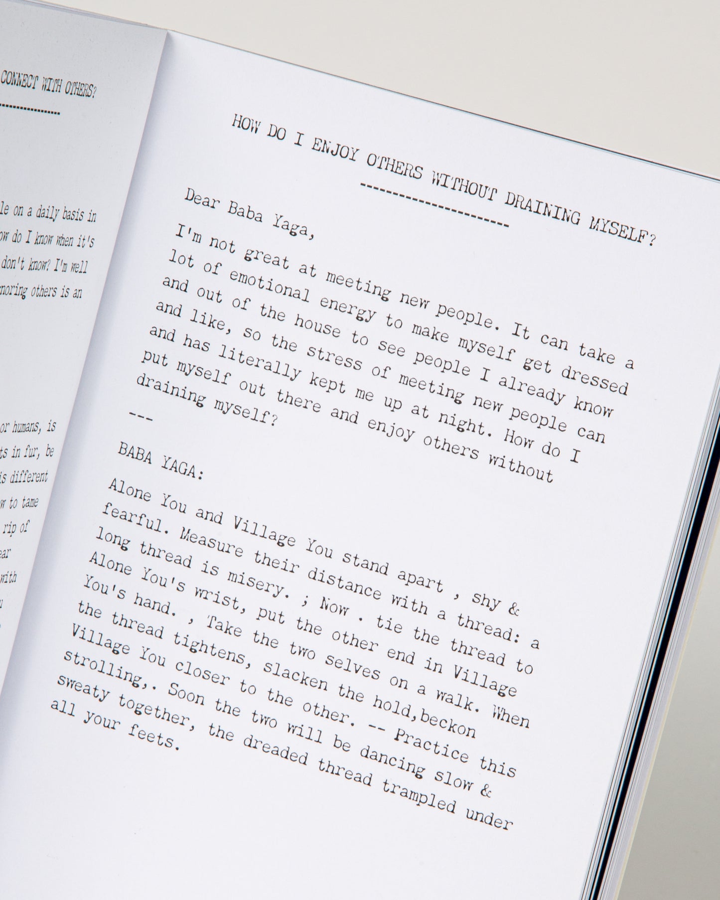 An open book with white pages and black lettering. Shown lying flat open from the front.