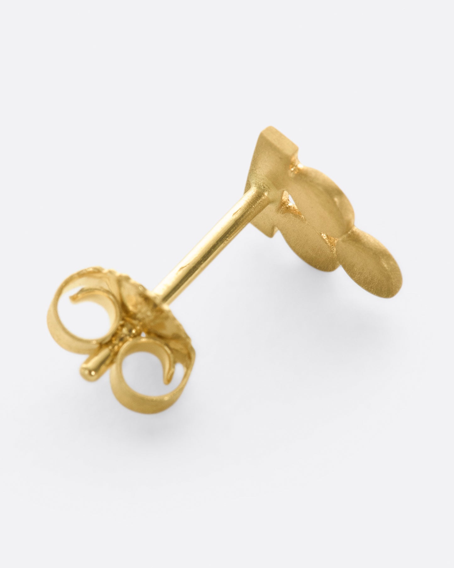 A balancing act, this yellow gold stud earring is comprised of three circles, perfectly in tune with a rectangle.