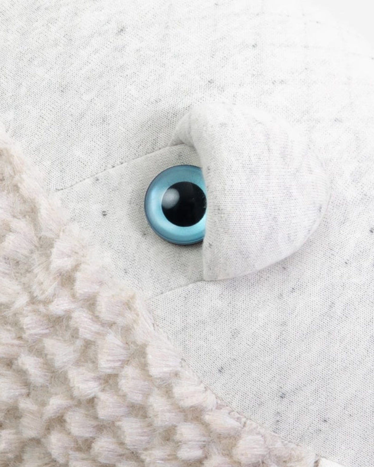 A light colored, wide-eyed whale to snuggle.