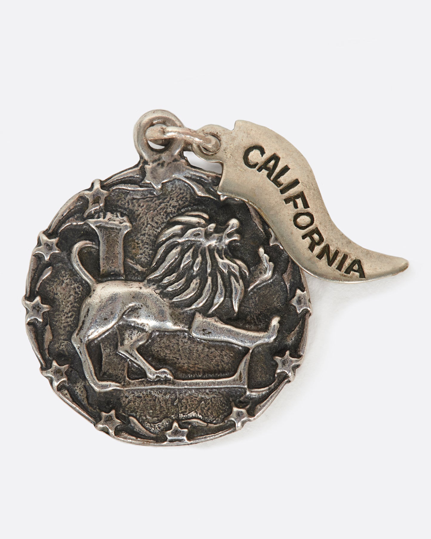 A round medal pendant with your zodiac sign and a California pennant.