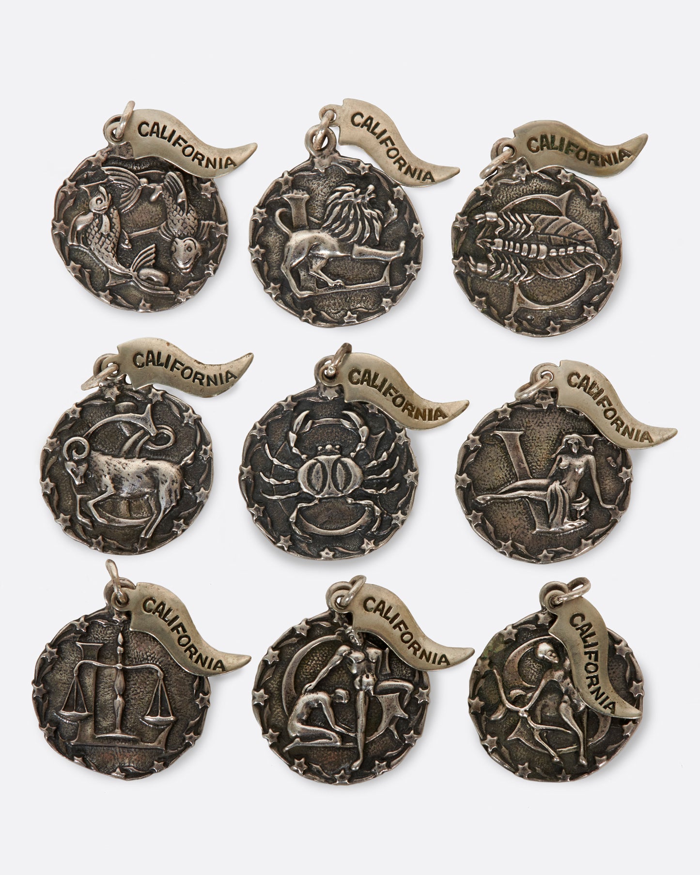 A round medal pendant with your zodiac sign and a California pennant.
