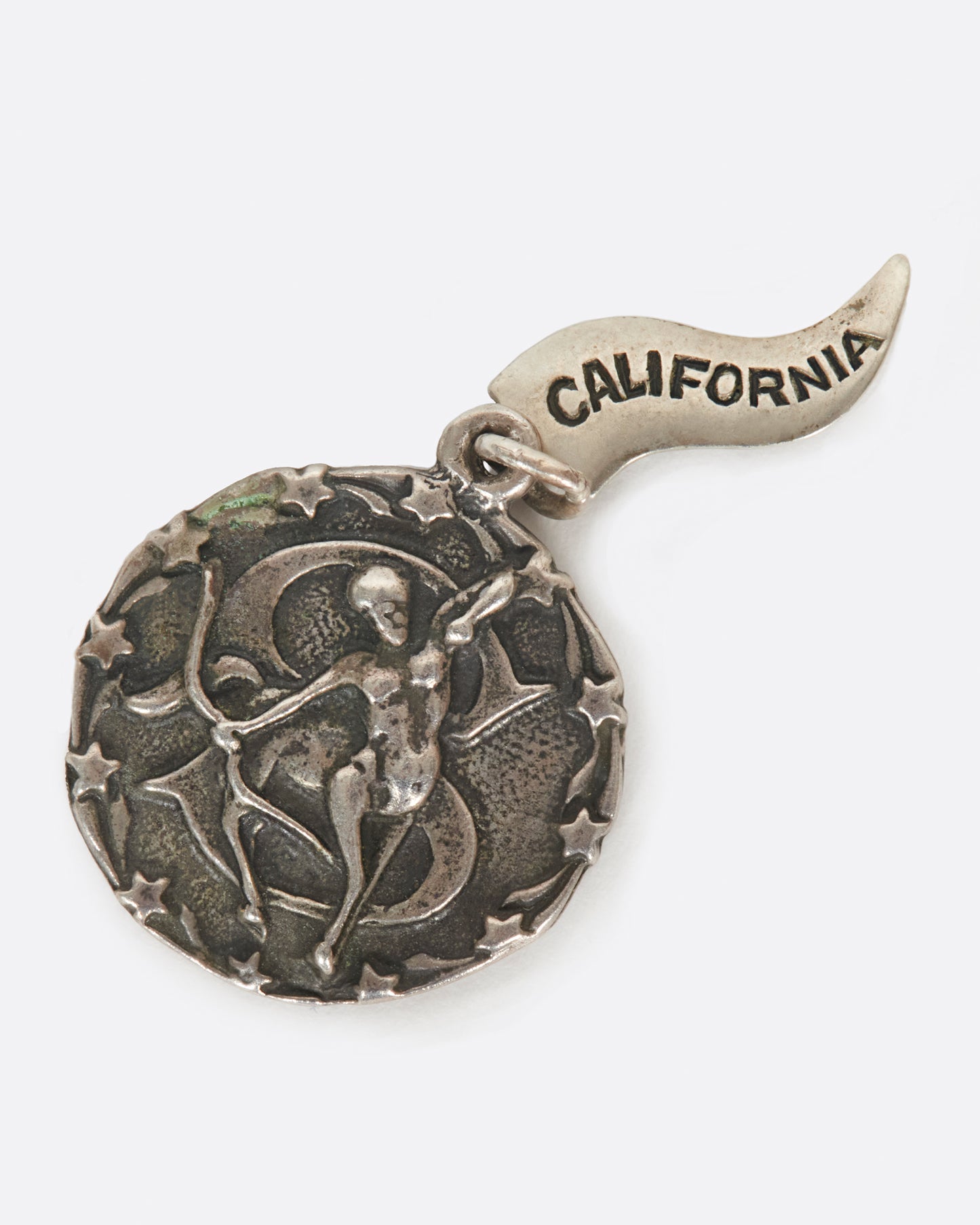 A round medal pendant with your zodiac sign and a California pennant.