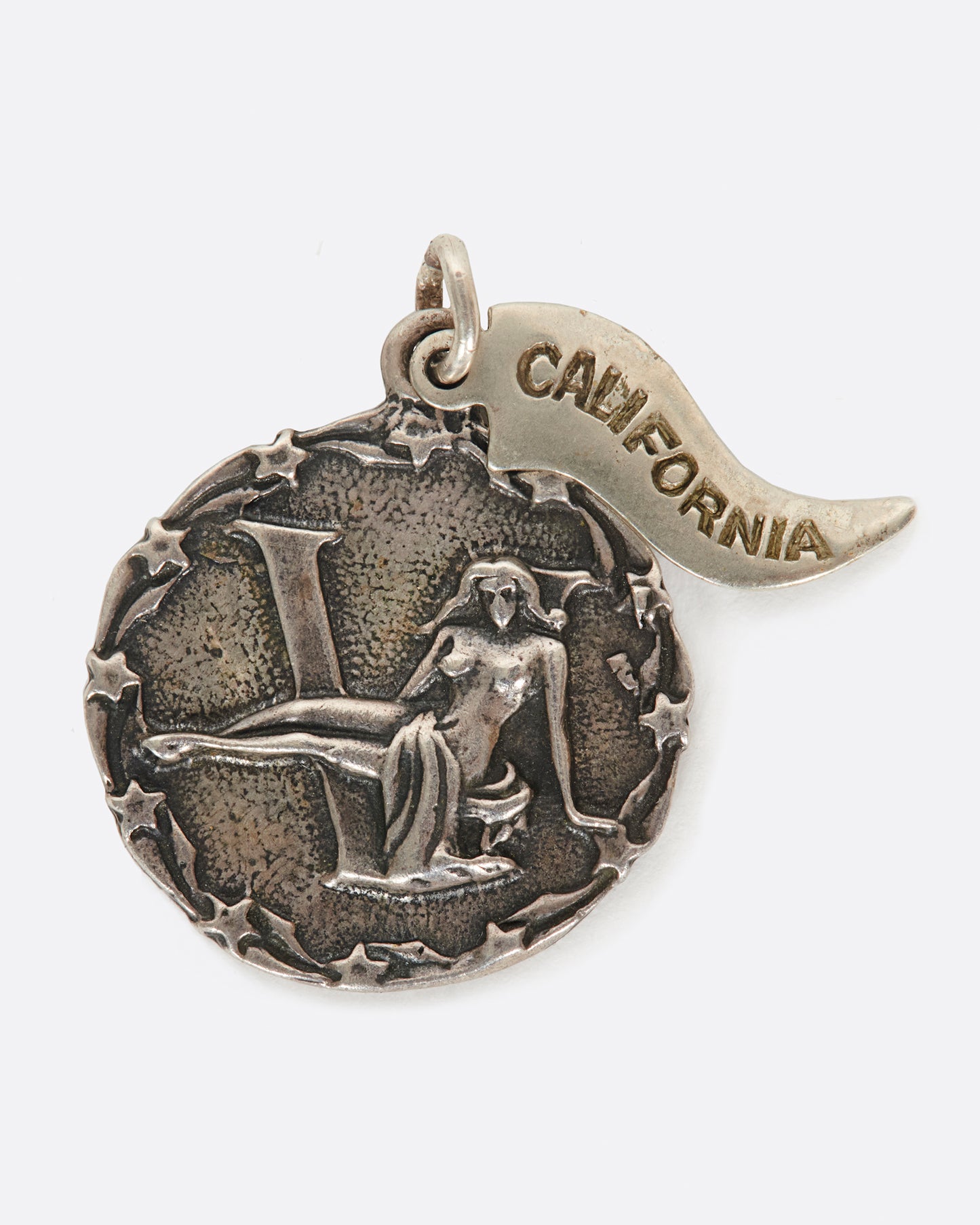 A round medal pendant with your zodiac sign and a California pennant.