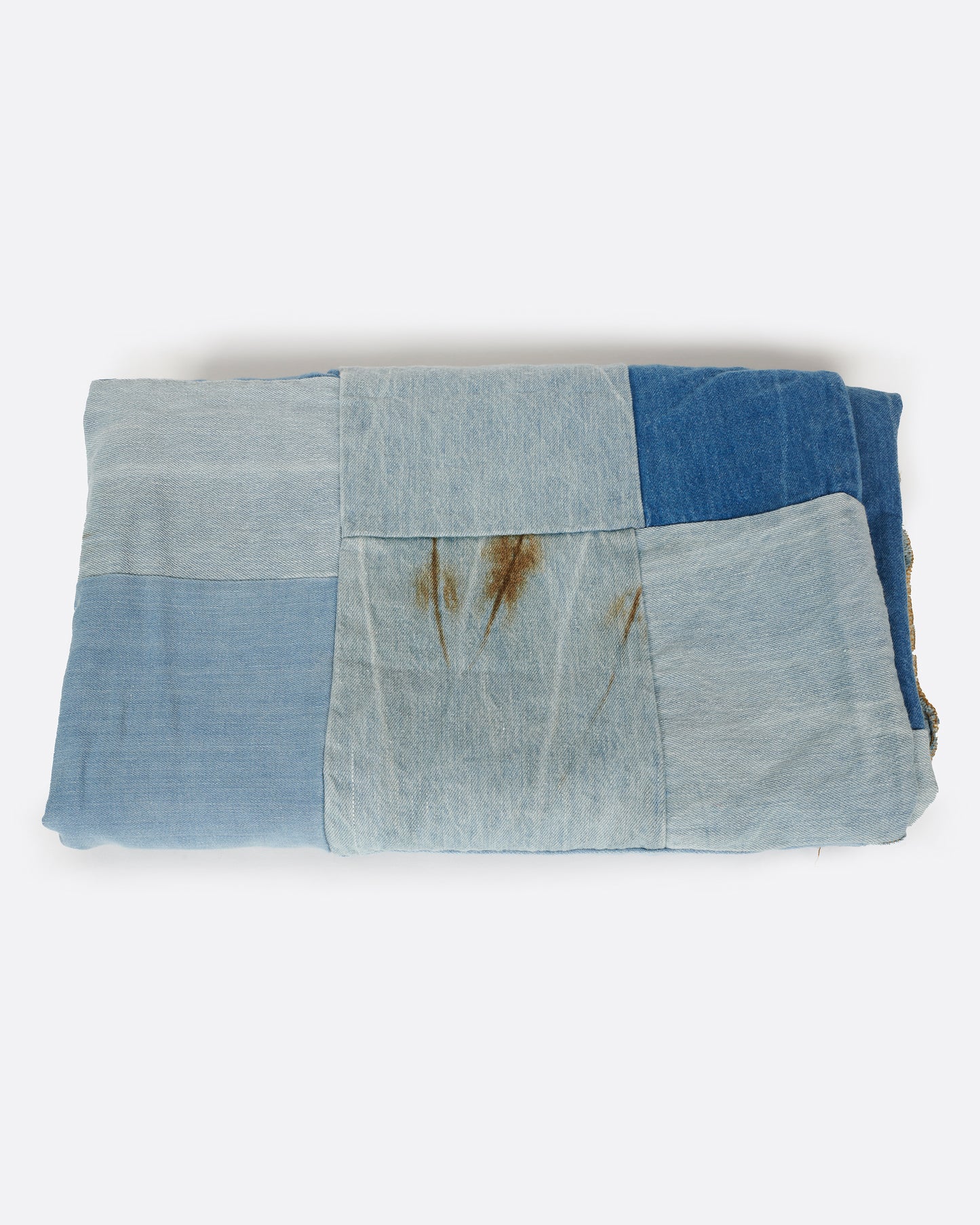 A handcrafted blanket made from pieces of dead stock denim, perfect for picnics.