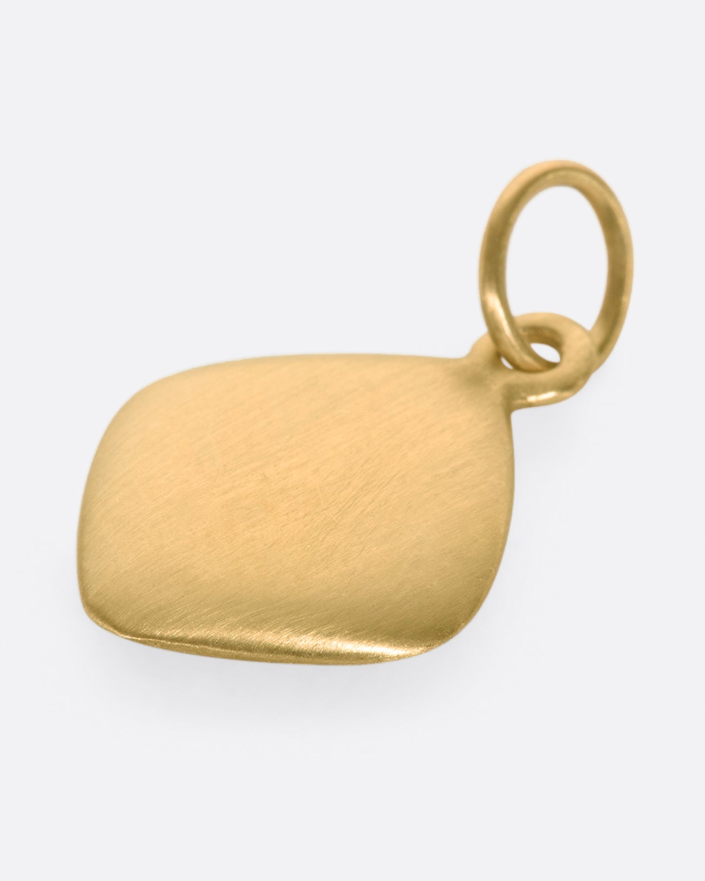 A rounded square tag, turned on its edge, with a line of gray diamonds down the center.