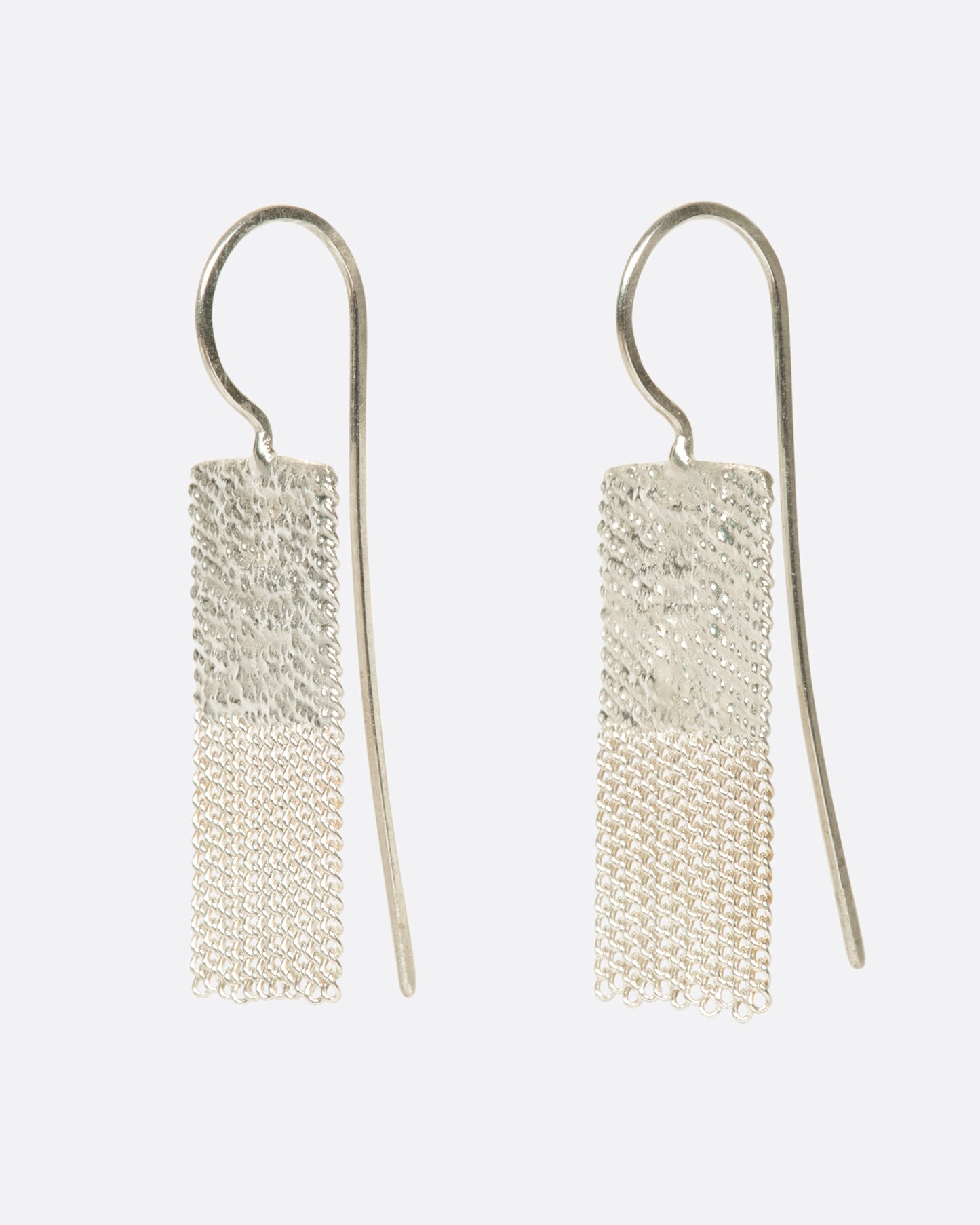 two silver earrings that are two squares stacked. the top square is solid and the bottom one is chains. there are silver hooks attached to the top.