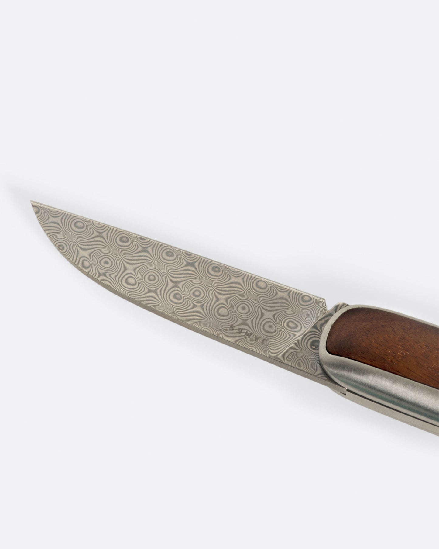 A close up of a pocket knife with a rosewood handle and damasteel blade. Shown lying flat from the side.