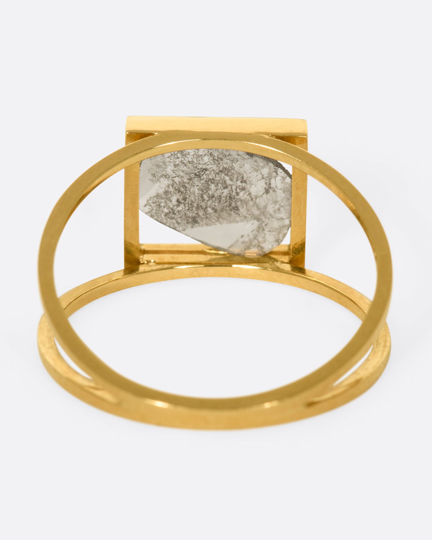 A split shank ring with a square window framing a salt and pepper diamond slice.