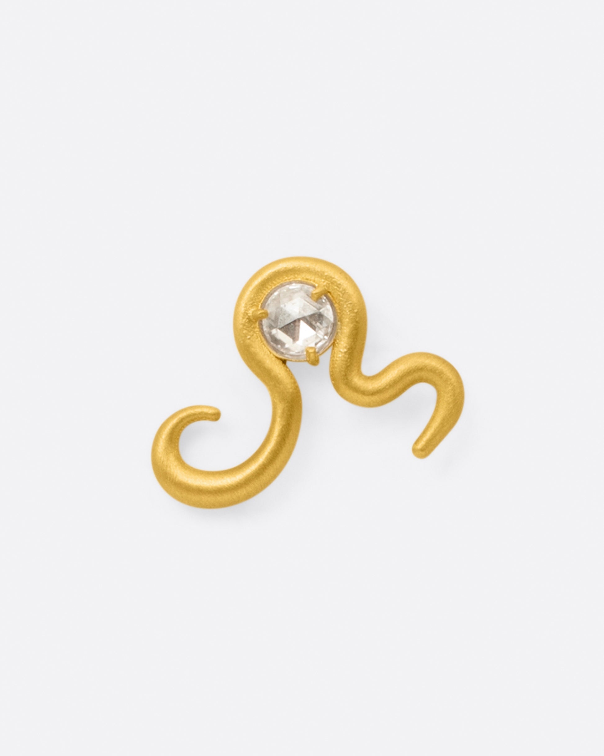 A high karat yellow gold curved snake stud earring with a rose cut diamond at its center, shown from the front.