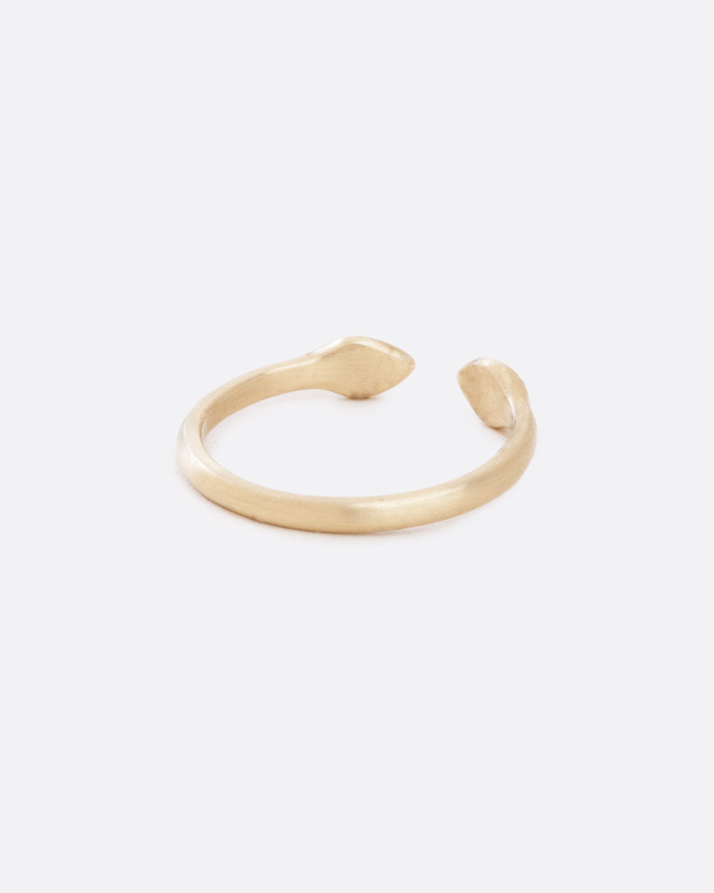 A yellow gold ring with an open front. The front pieces are more bulbous than the band. Shown from the back.