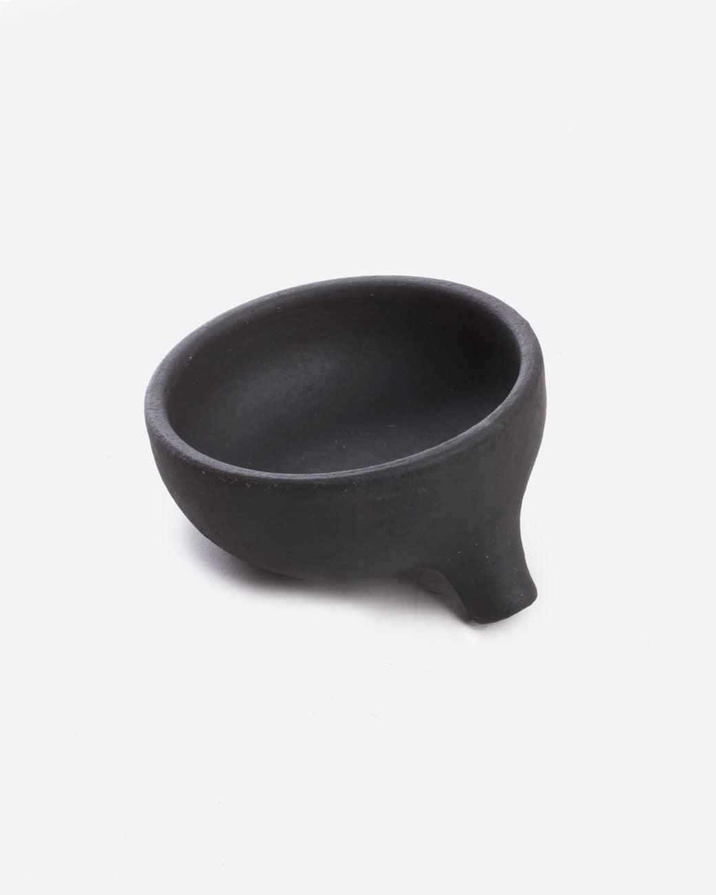 A black stoneware soap dish with a drainage spout. Shown from the front.