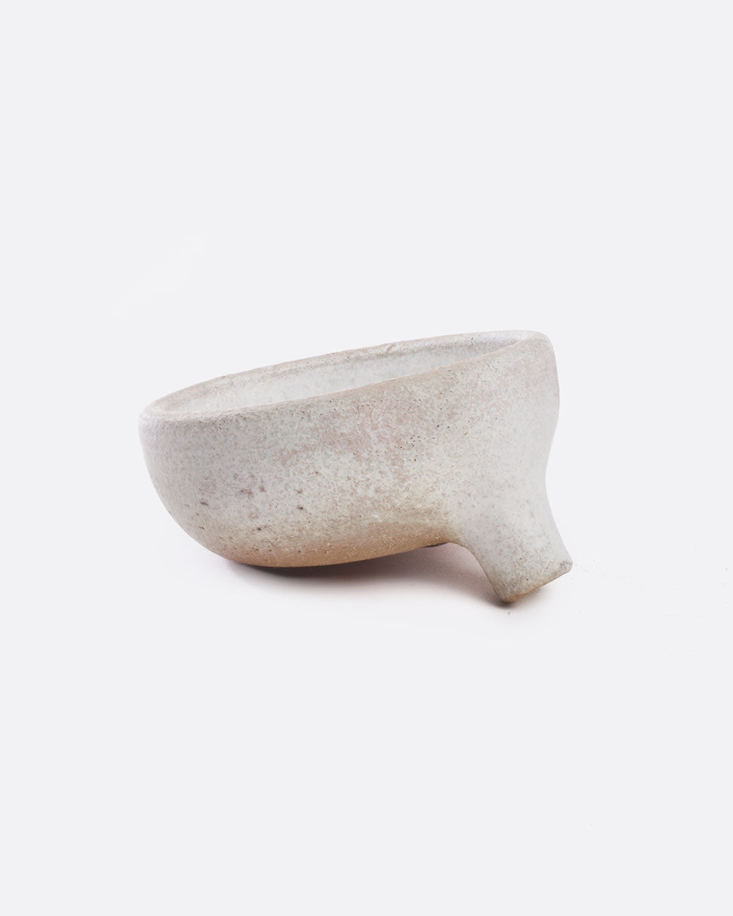 A white stoneware soap dish with a drainage spout. Shown from the front.