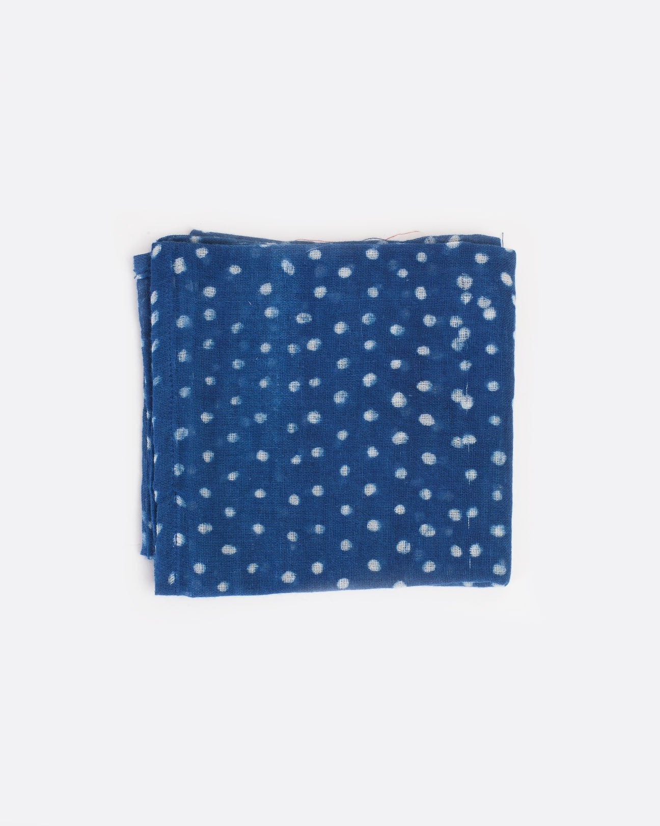 Light blue bandana with white polka dots, shown folded.