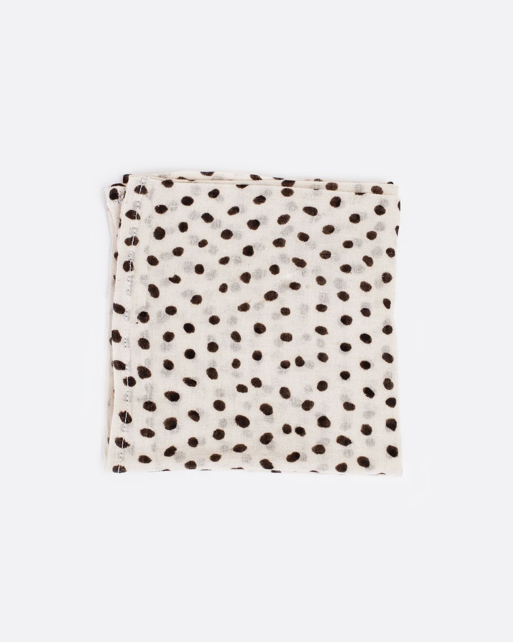 Cream bandana with black polka dots, shown folded.