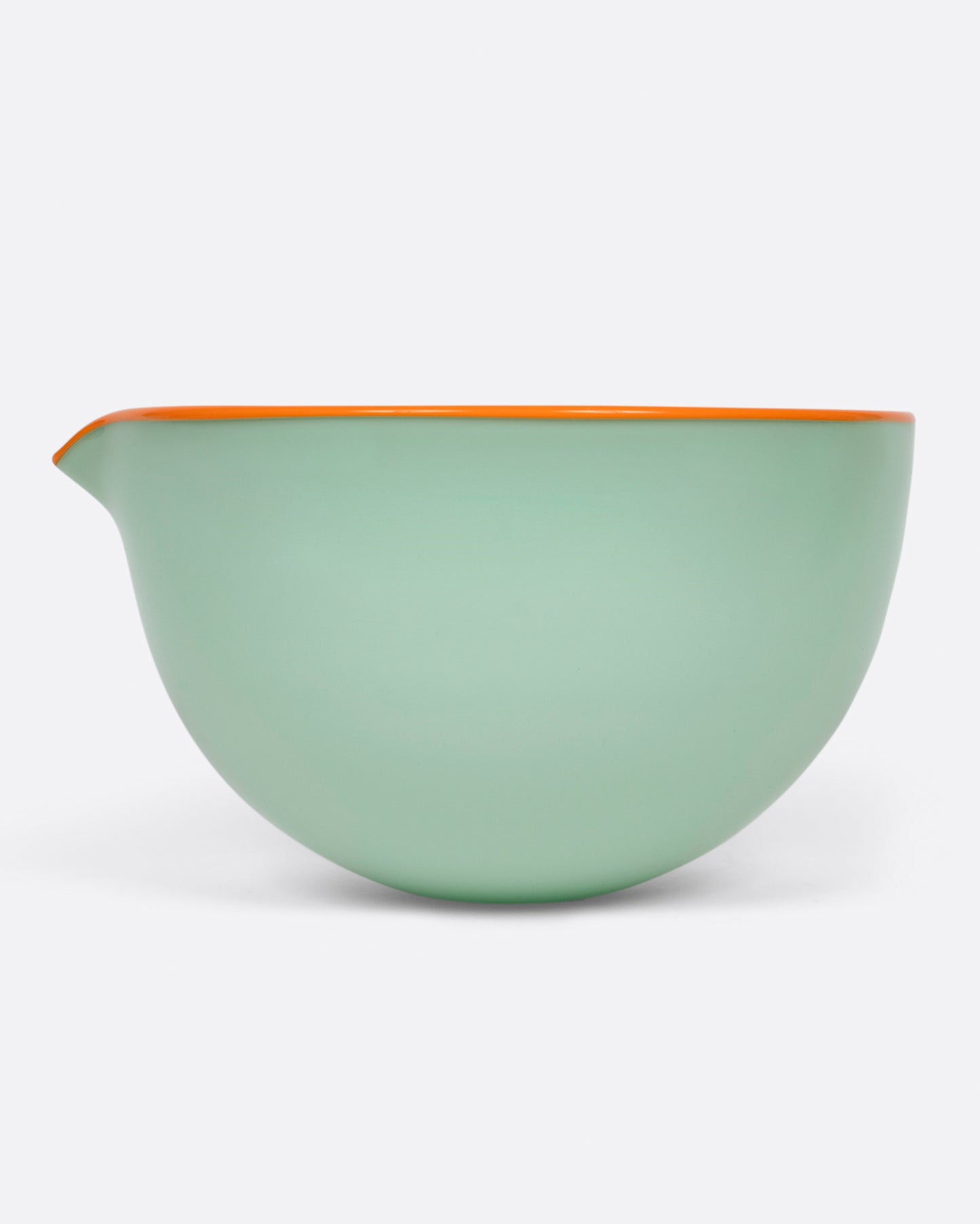 A green spouted glass pouring bowl, with an orange edge shown from the side.