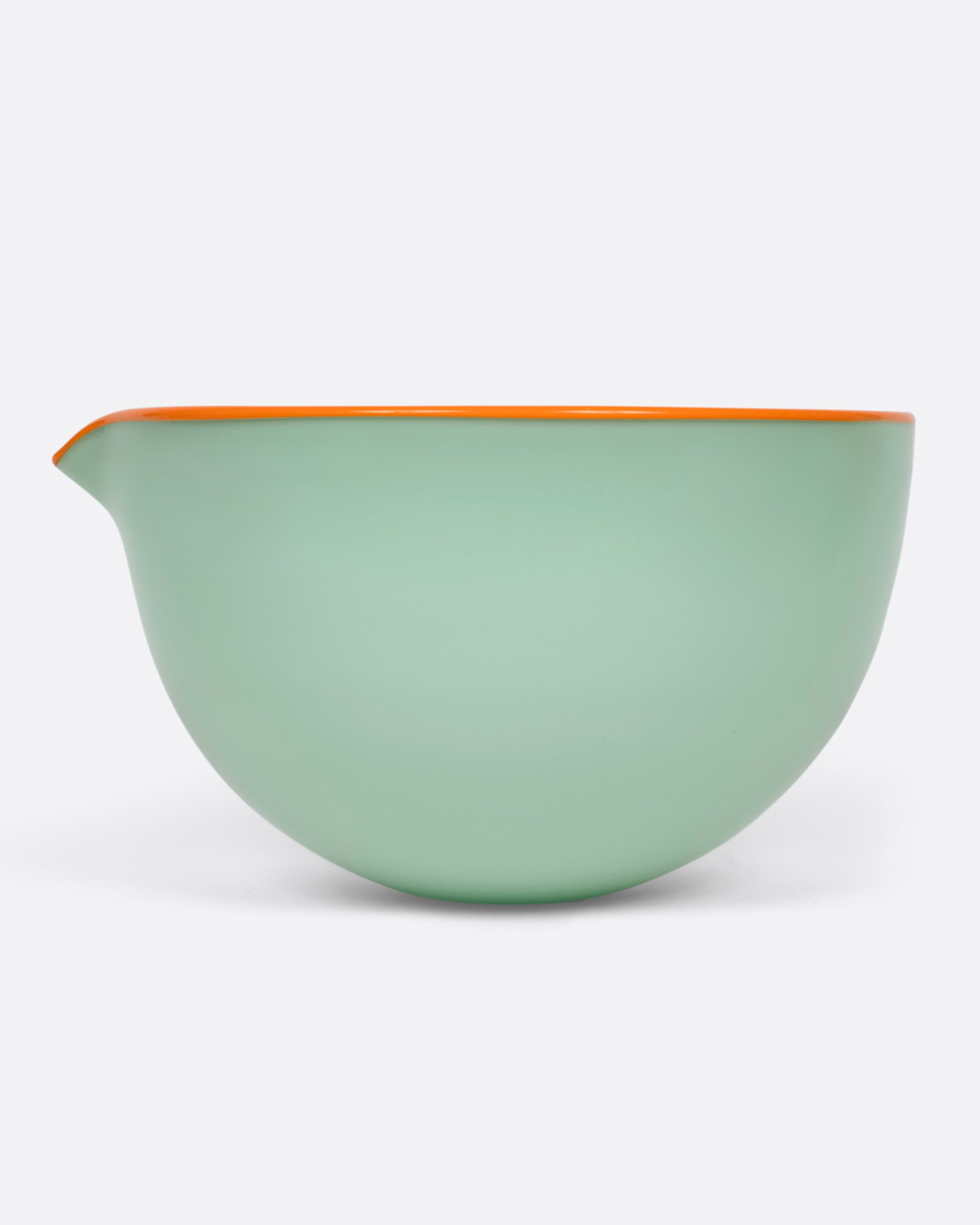 A green spouted glass pouring bowl, with an orange edge shown from the side.