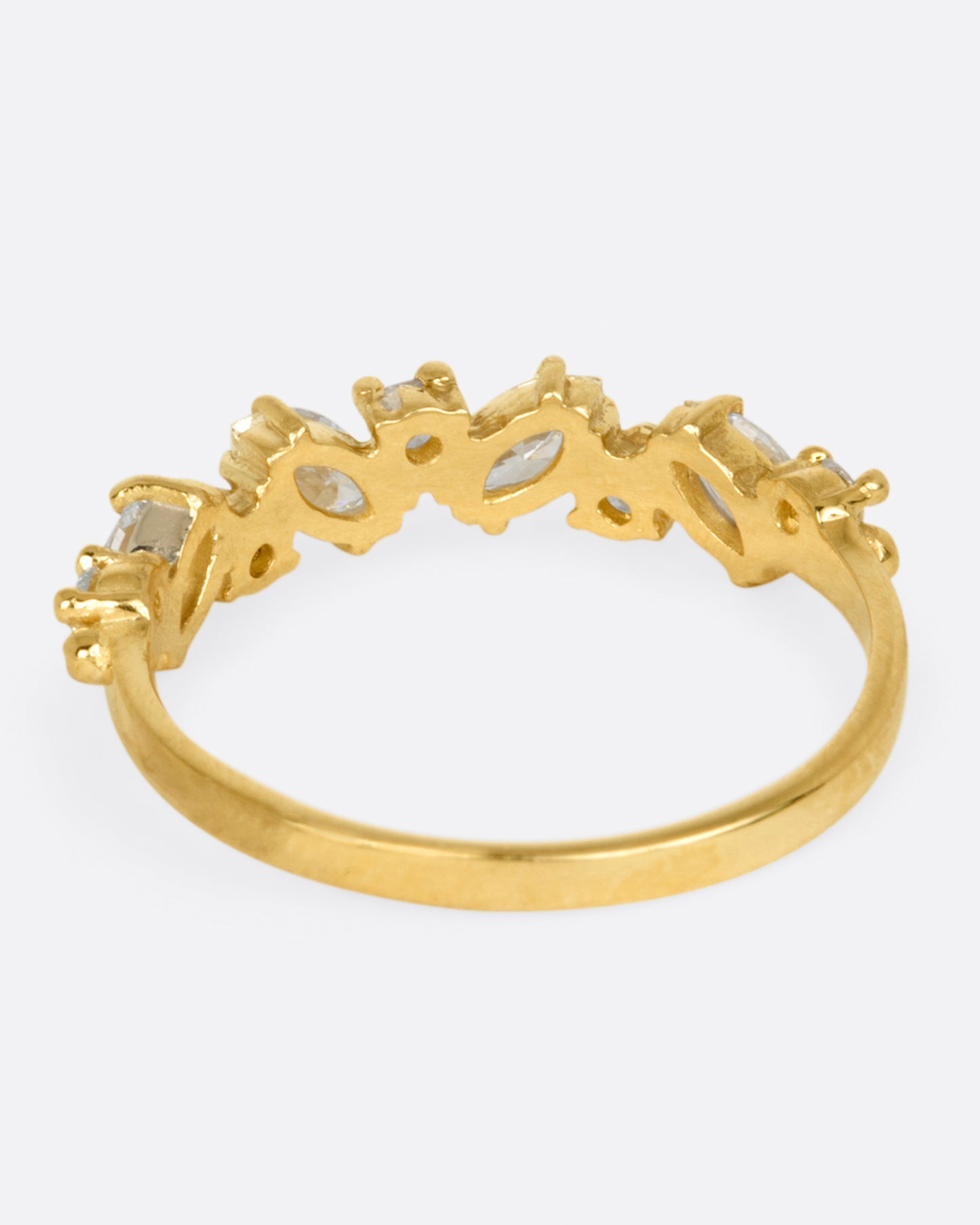A yellow gold ring with round and marquise diamonds. Shown from the back.