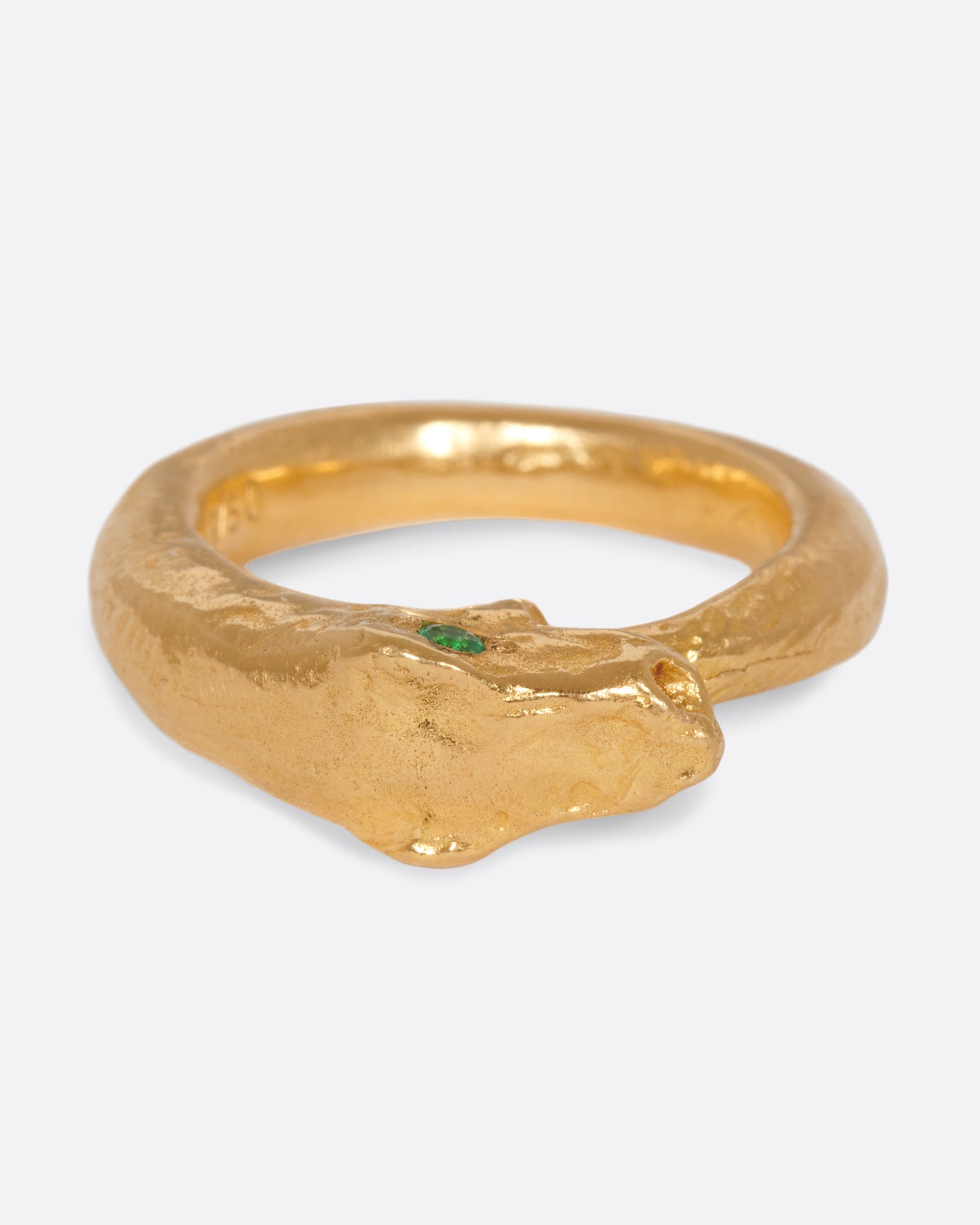A yellow gold ouroboros ring with a emerald eyed serpent catching its own tail. Shown from the front.