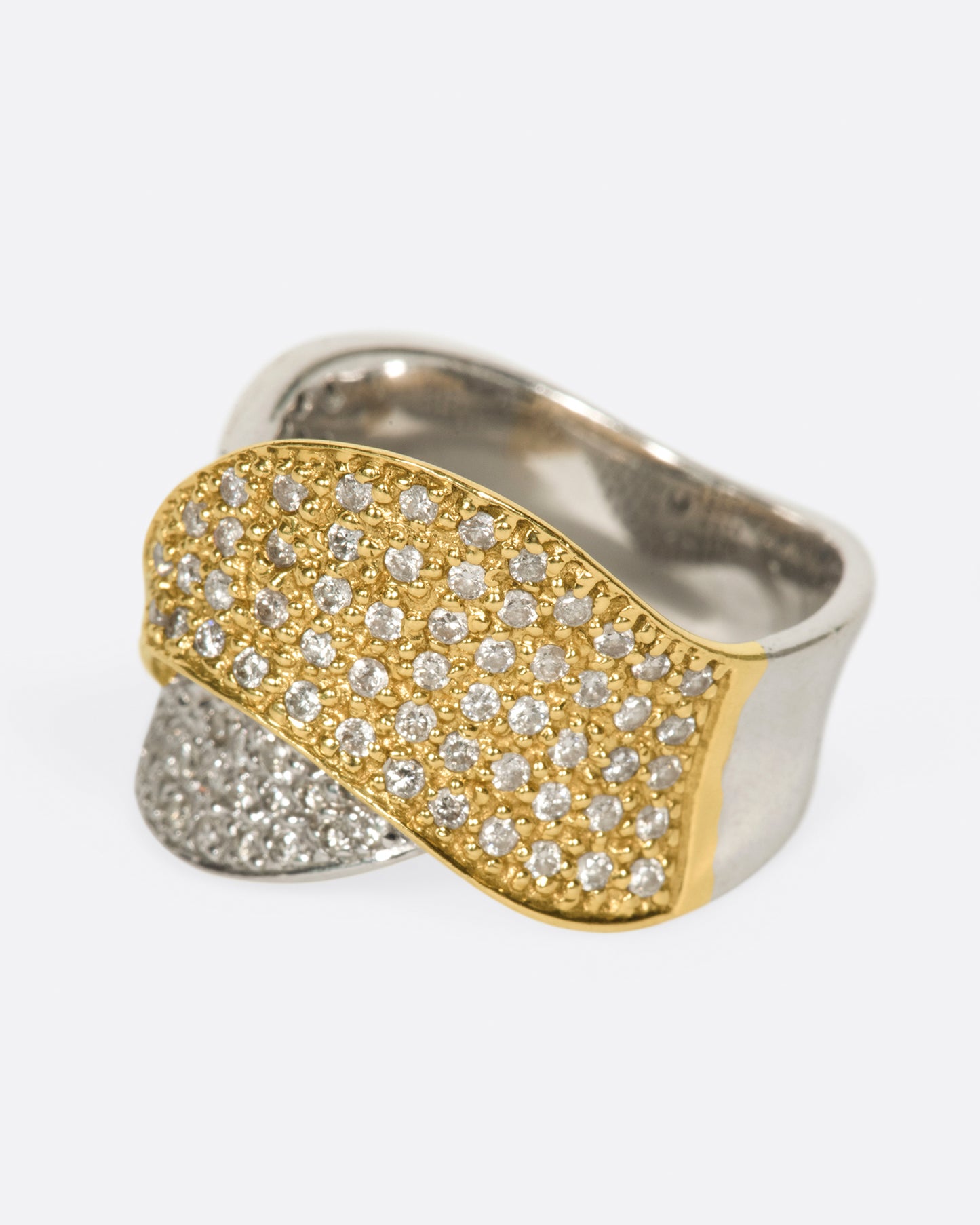 A half white gold, half yellow gold diamond-covered wrap shown from the side.