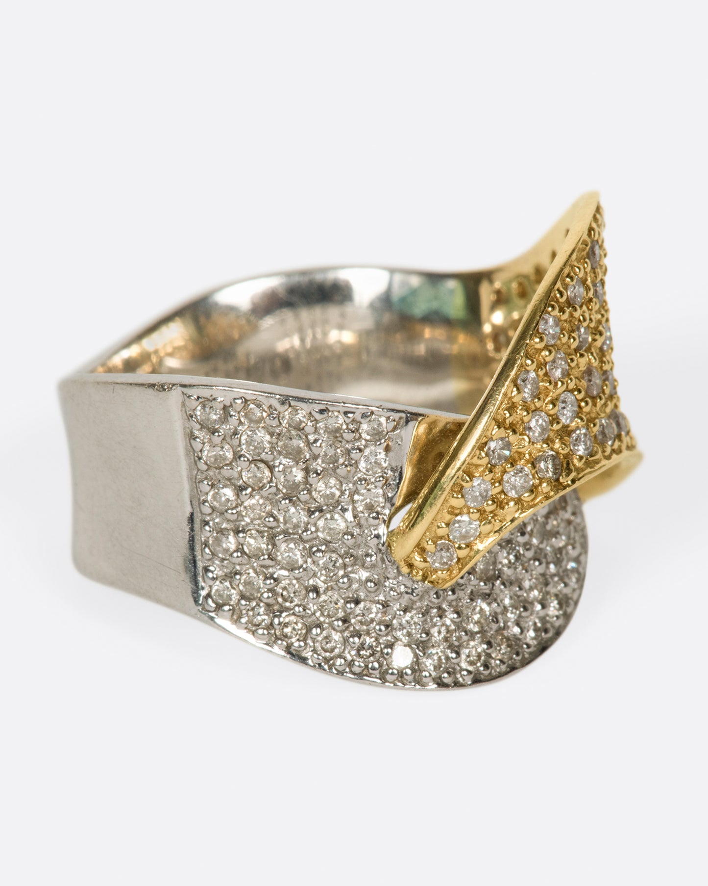 A half white gold, half yellow gold diamond-covered wrap shown from the side.