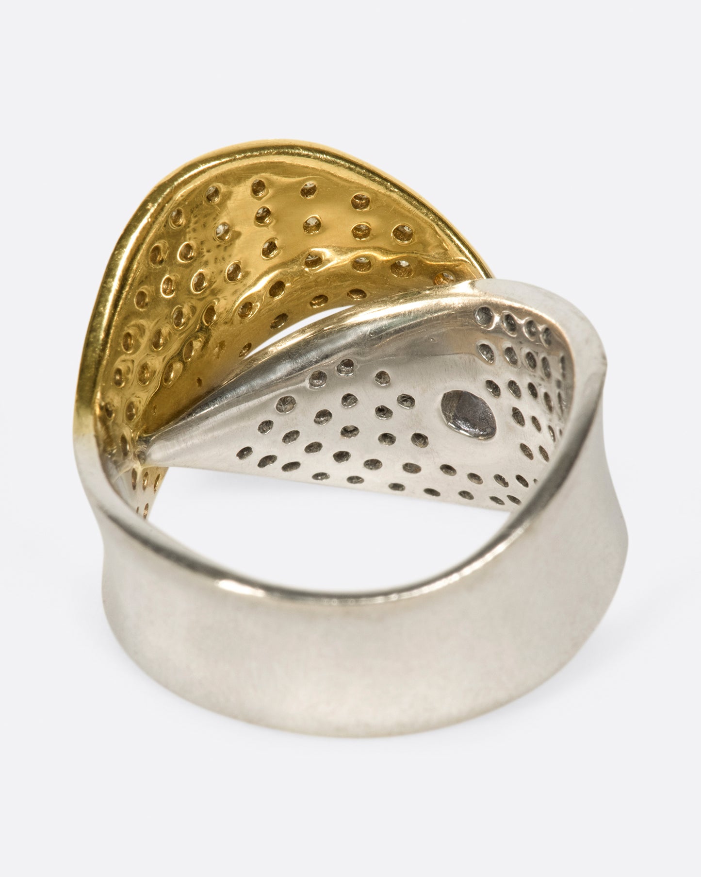 A half white gold, half yellow gold diamond-covered wrap shown from the back.