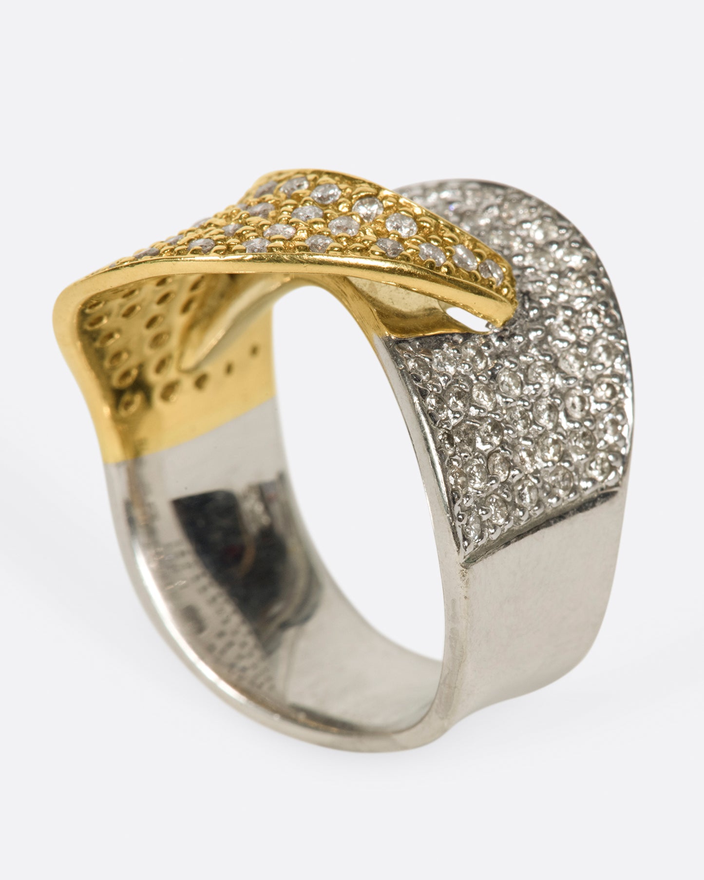 A half white gold, half yellow gold diamond-covered wrap shown from the side standing up.