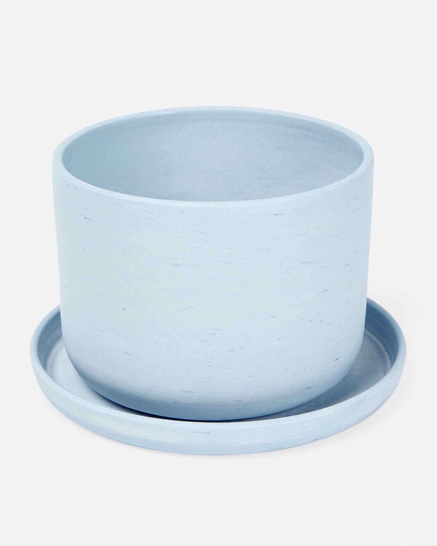 Smooth, matte, tinted porcelain planters with matching saucers.