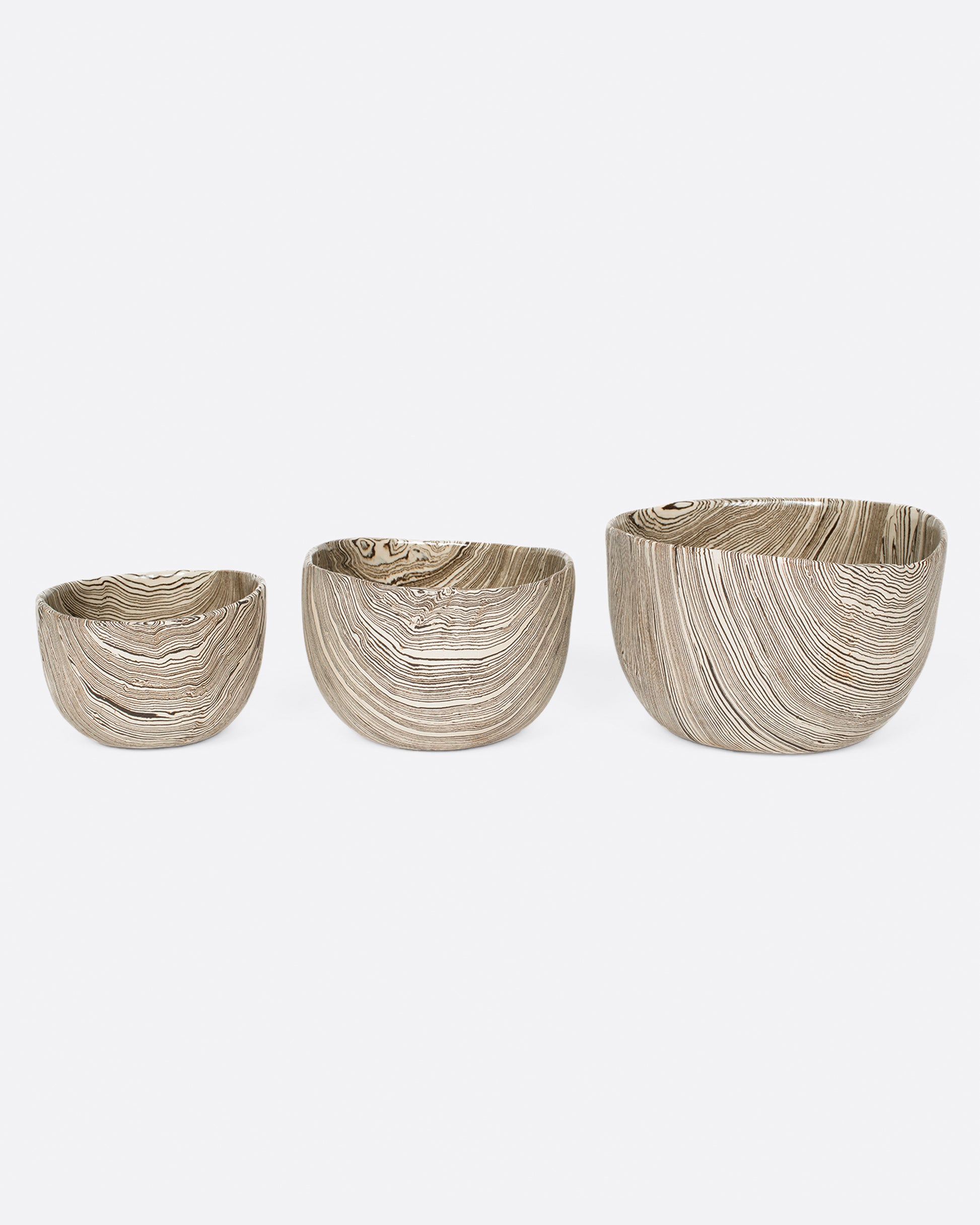 A group of three white and brown stoneware nerikomi bowls. Shown from smallest to biggest from the front.