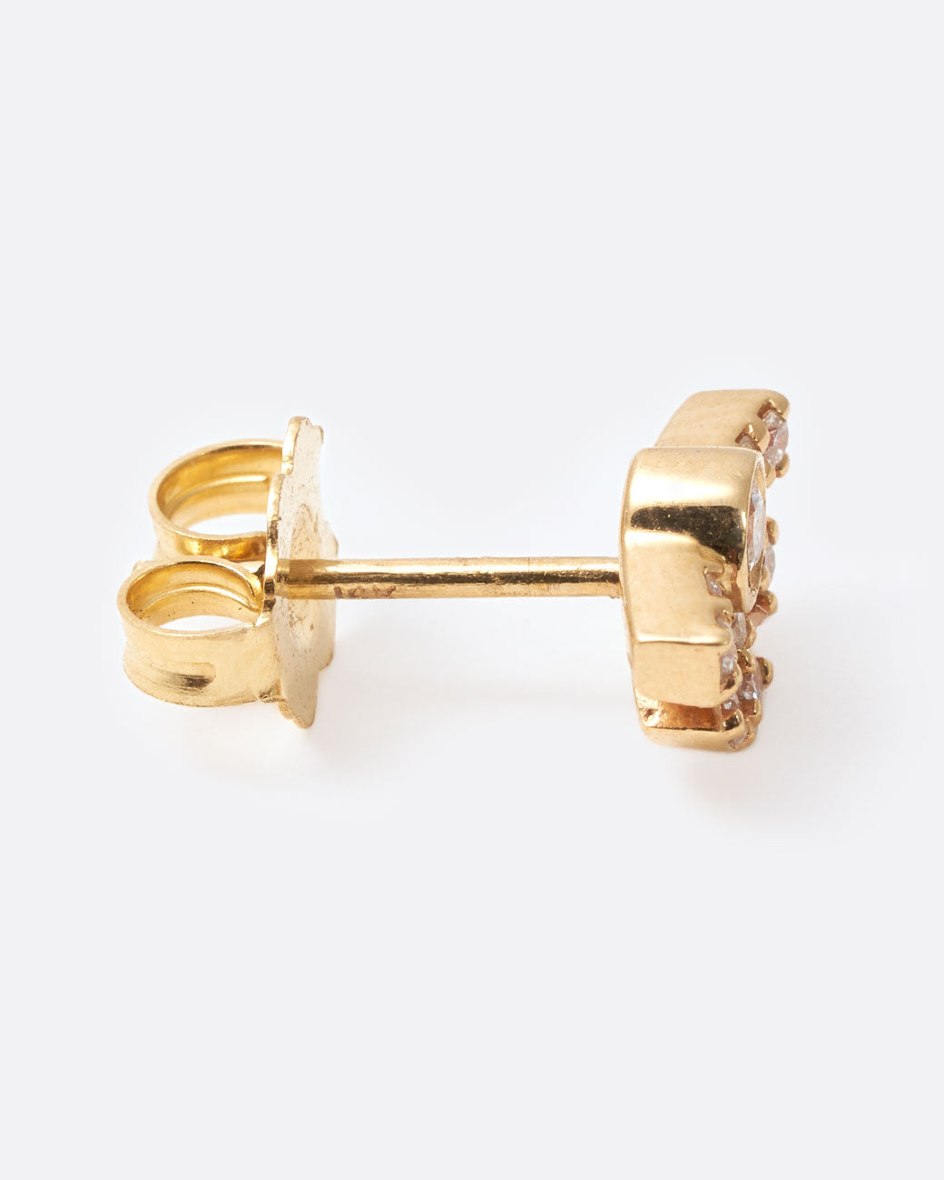 A yellow gold earring in the shape of a sun with rays with diamonds inlaid throughout. Shown from the side.