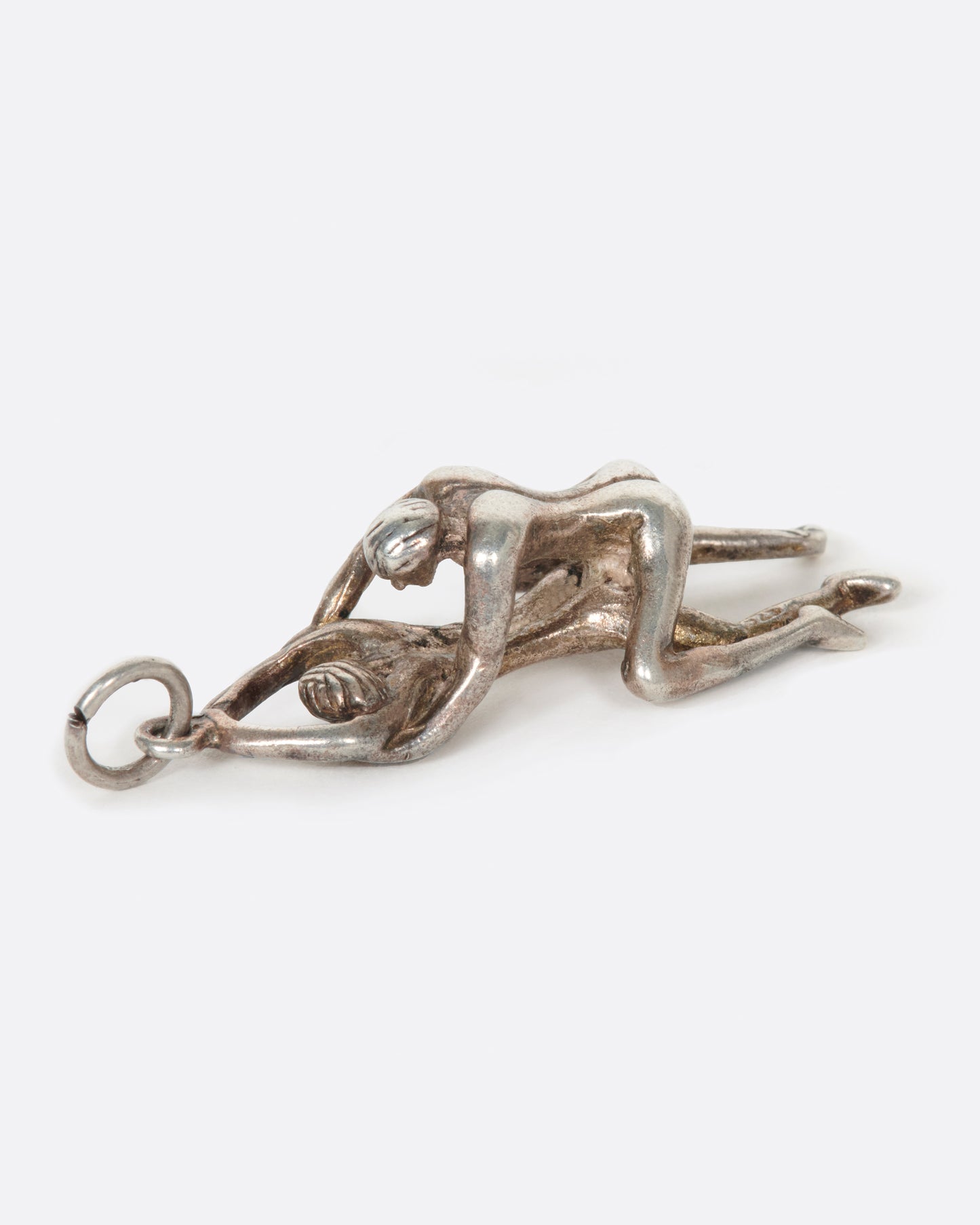 A vintage silver pendant of a couple enjoying a bit of TLC.