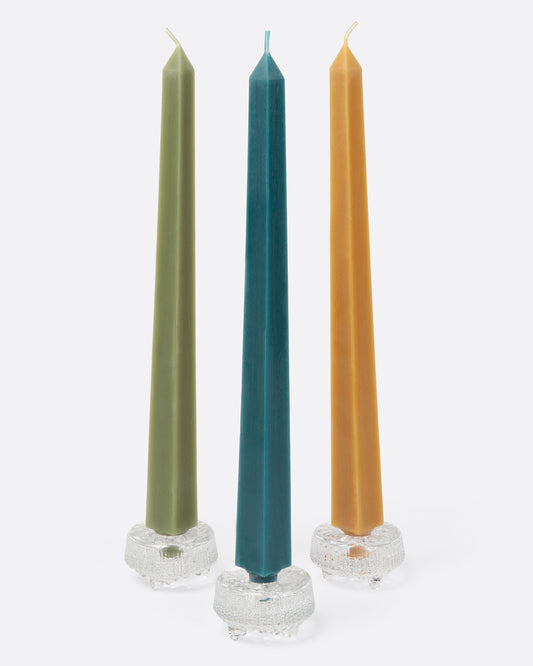 Three square taper candles in glass candle holders.
