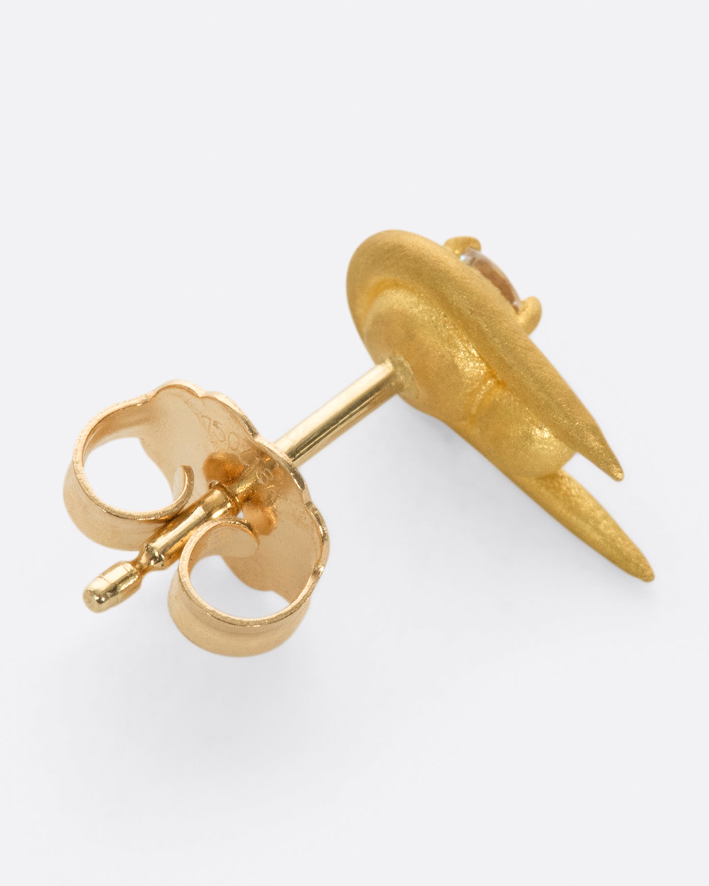 A curved high karat gold earring with a stacked sphere and brilliant cut diamond. Shown from the side.
