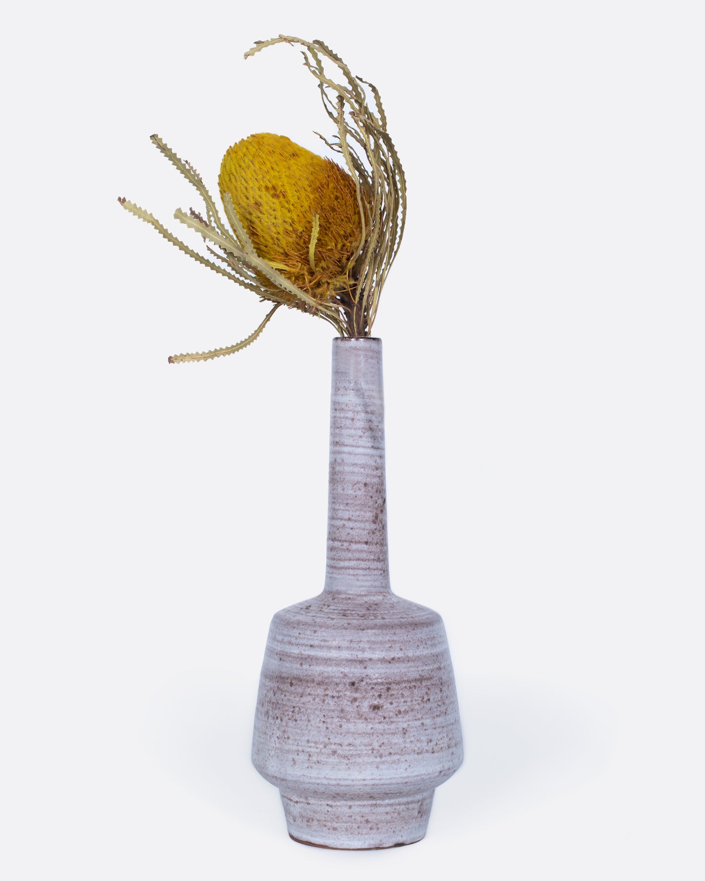 A tall stoneware vase with an elongated neck.