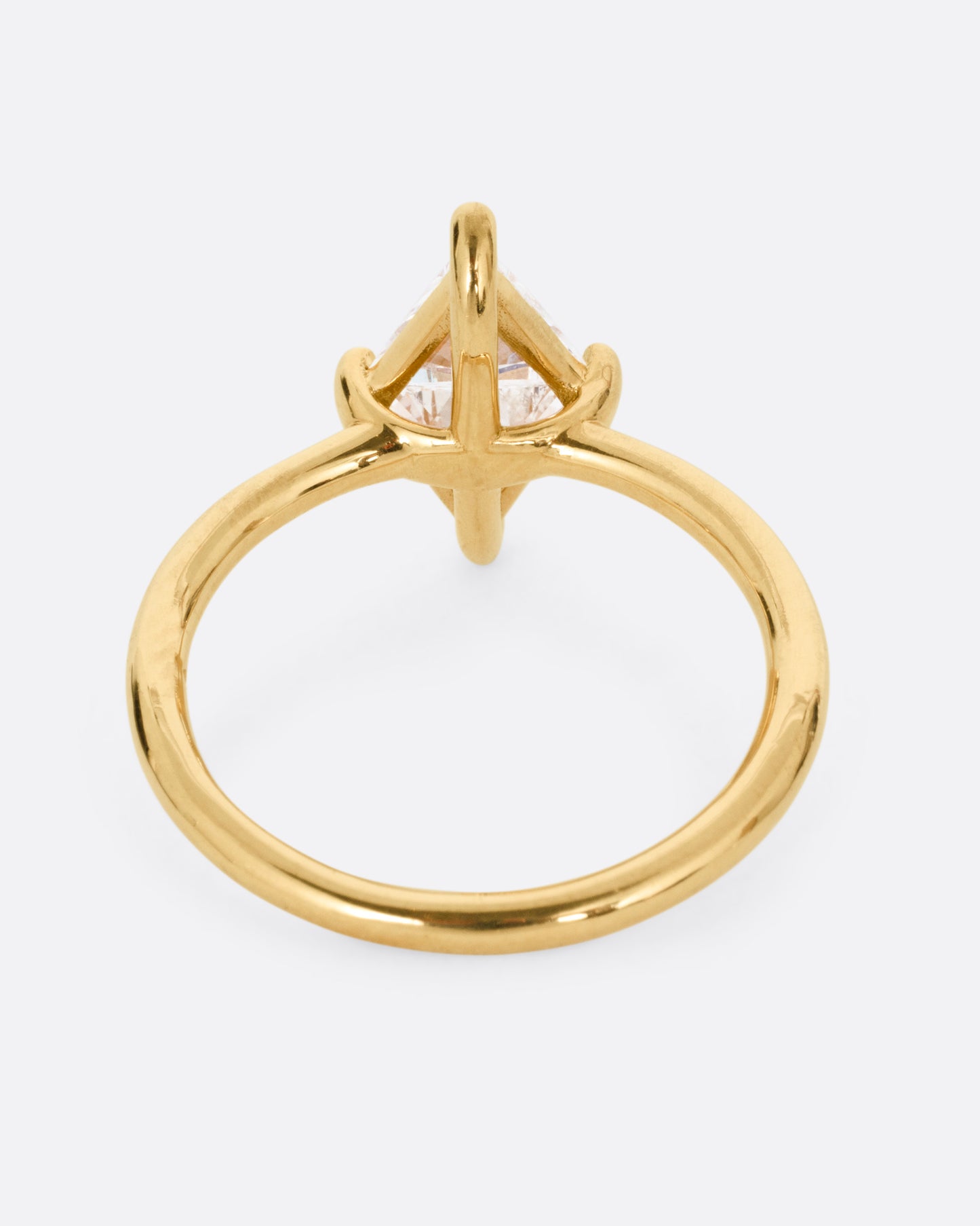 A yellow gold ring with two triangular diamonds mirroring each other. Shown from the back.