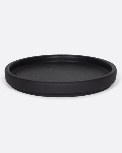 This black ceramic plate with a raised lip and matte black finish looks beautiful with tall candles and works great for small plants, too.