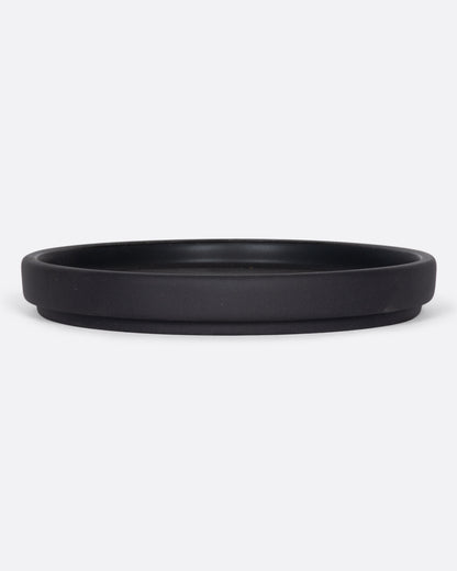 This black ceramic plate with a raised lip and matte black finish looks beautiful with tall candles and works great for small plants, too.
