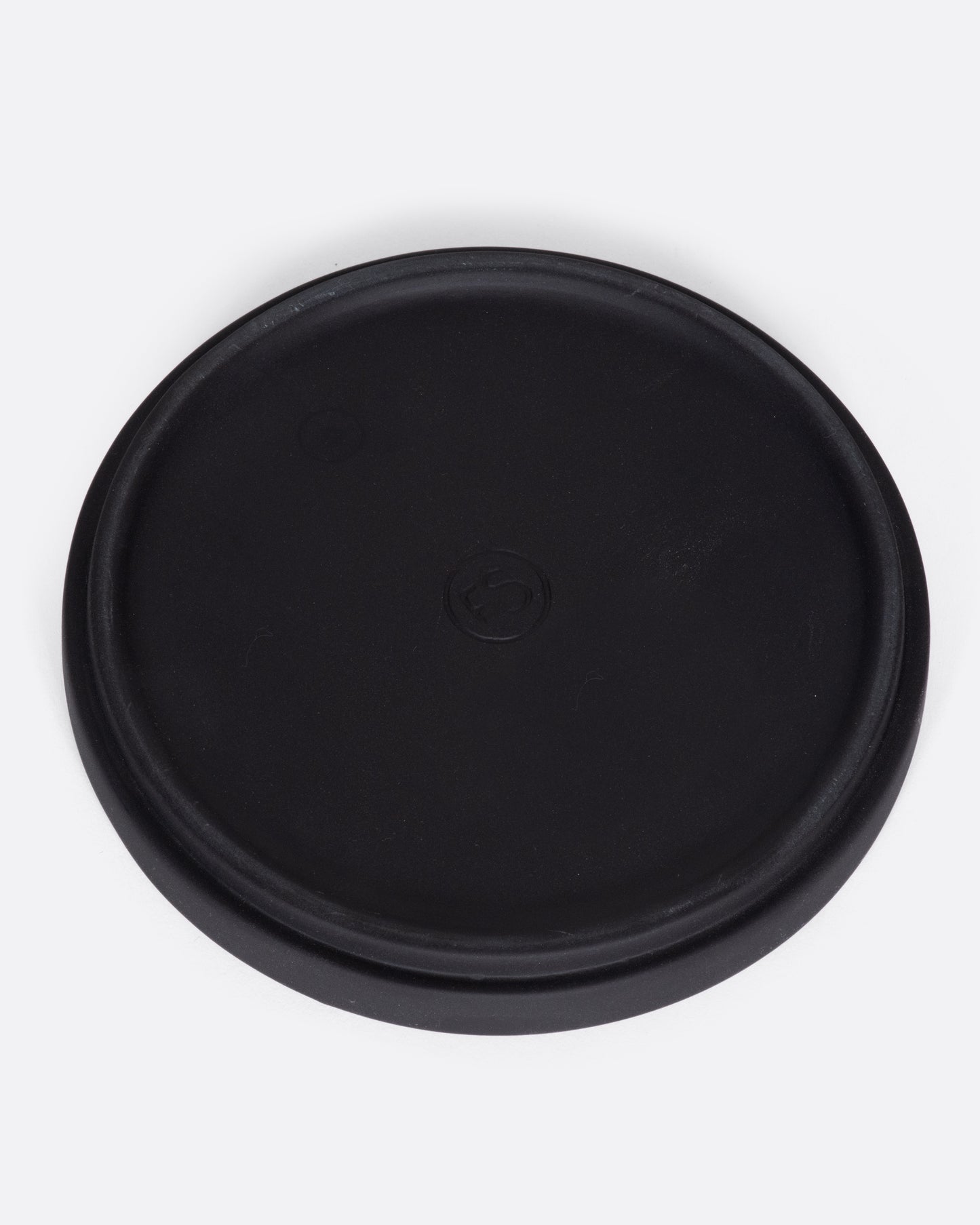 This black ceramic plate with a raised lip and matte black finish looks beautiful with tall candles and works great for small plants, too.
