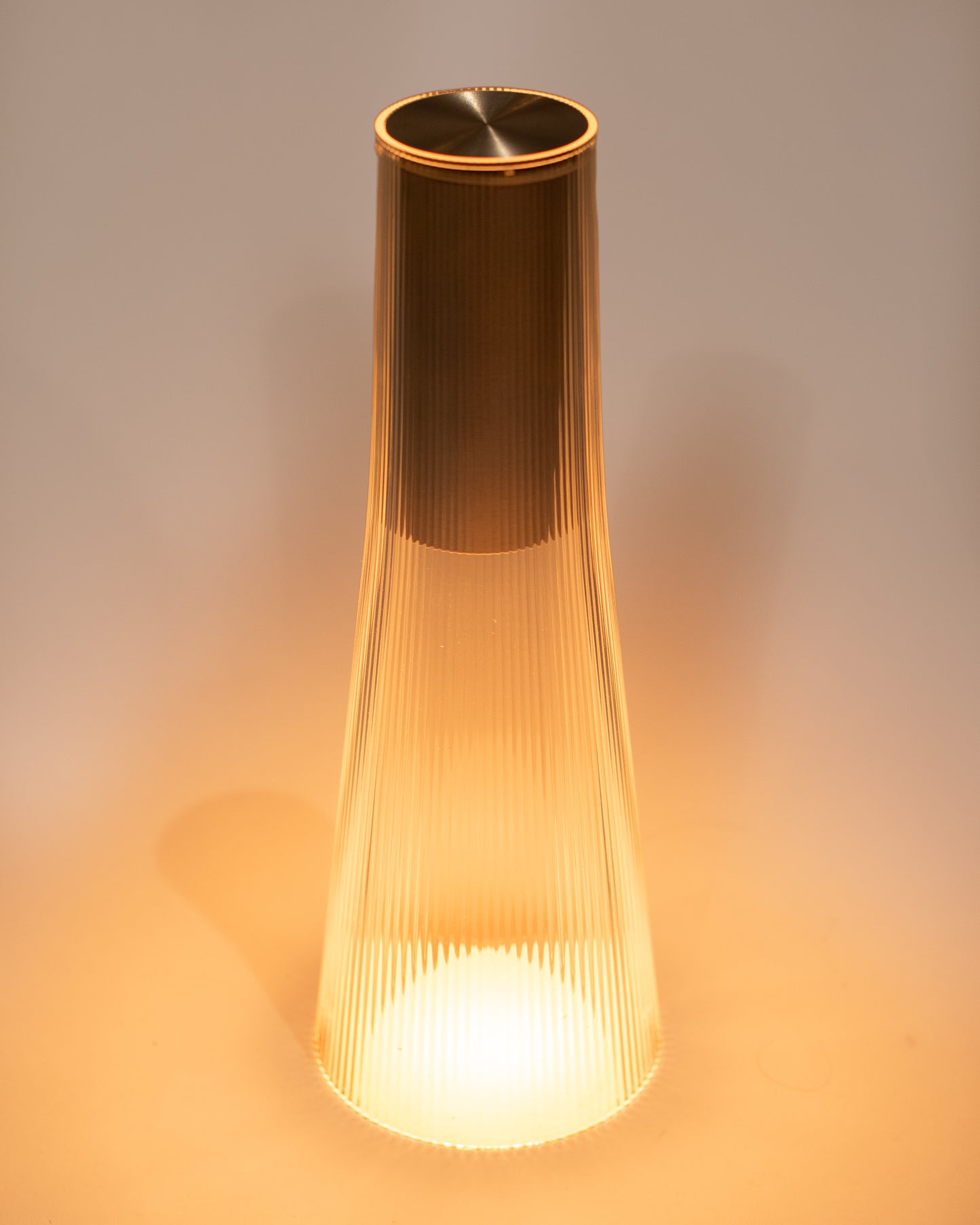 A rechargeable flared table lamp in a silver color way.