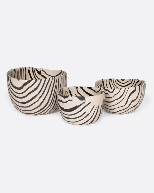 These small-batch ceramic bowls are made with a traditional Japanese Nerikomi technique that creates an intricate, marbled design by layering and compressing clay. Each bowl has a unique, zebra-striped design that feels other-worldly and timeless. Available in small, medium, and large sizes.