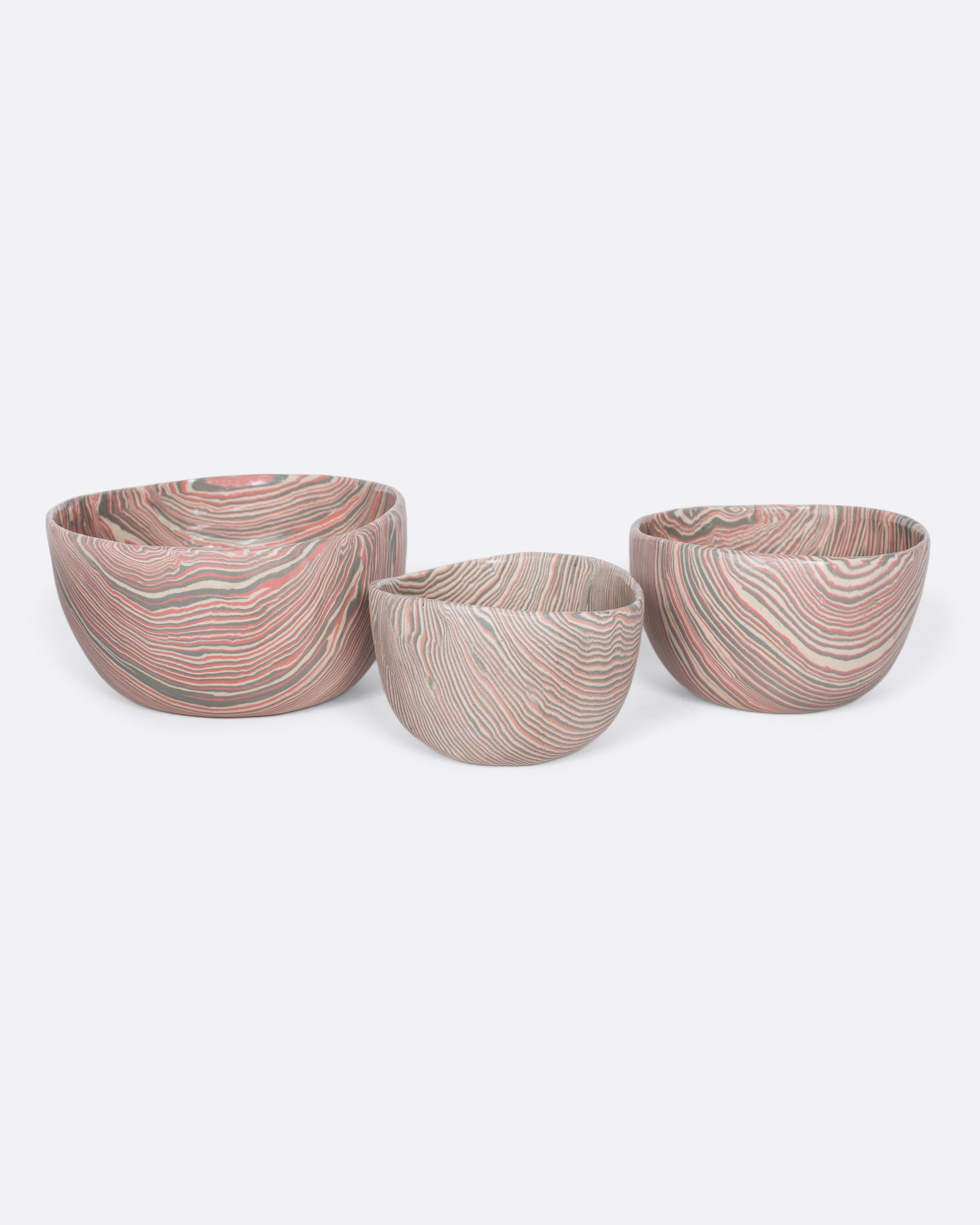 These small-batch ceramic bowls are made with a traditional Japanese nerikomi technique that creates an intricate, marbled design by layering and compressing clay. This timeless style feels plucked from desert sandstone with flowing hues of pink, white, and grey. Available in small, medium, and large sizes.