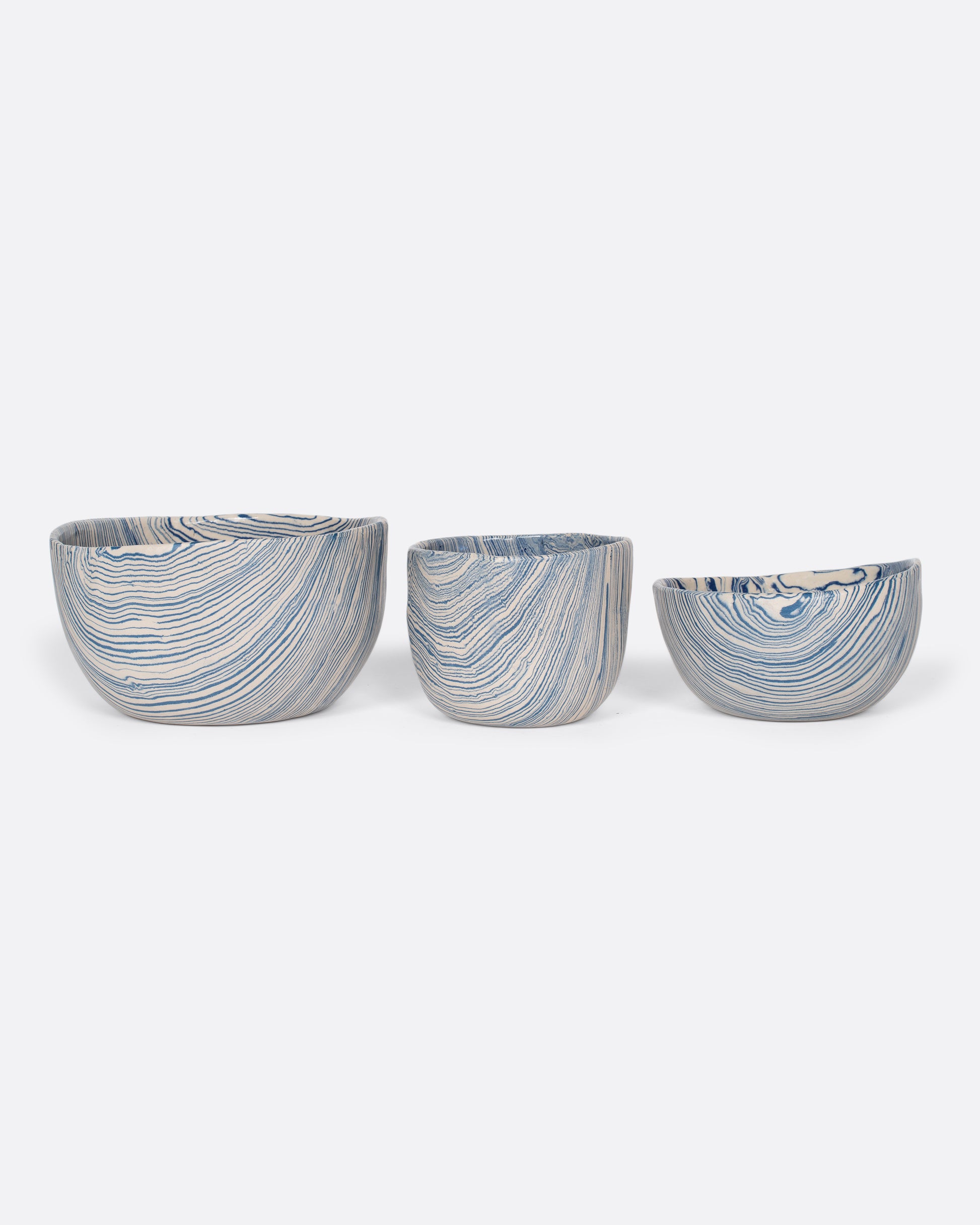 These small batch ceramic bowls look plucked straight from the ocean, with flowing hues of blue and white. They're made with a traditional Japanese Nerikomi technique that creates an intricate, marbled design by layering and compressing clay. Available in small, medium, and large sizes.