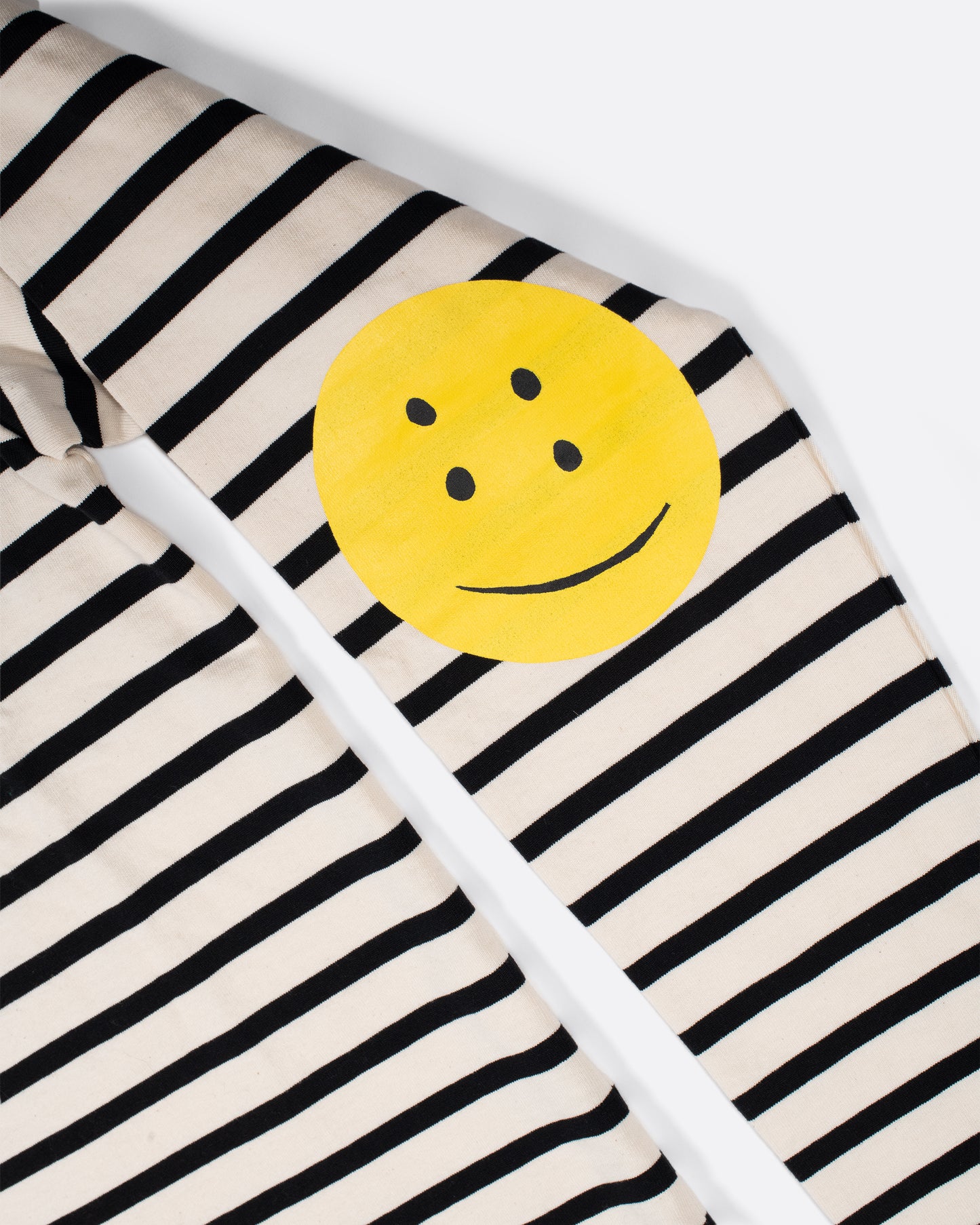 A black and white striped, cotton, crewneck shirt with Kapital's fan favorite rainbow smiley elbow patches.