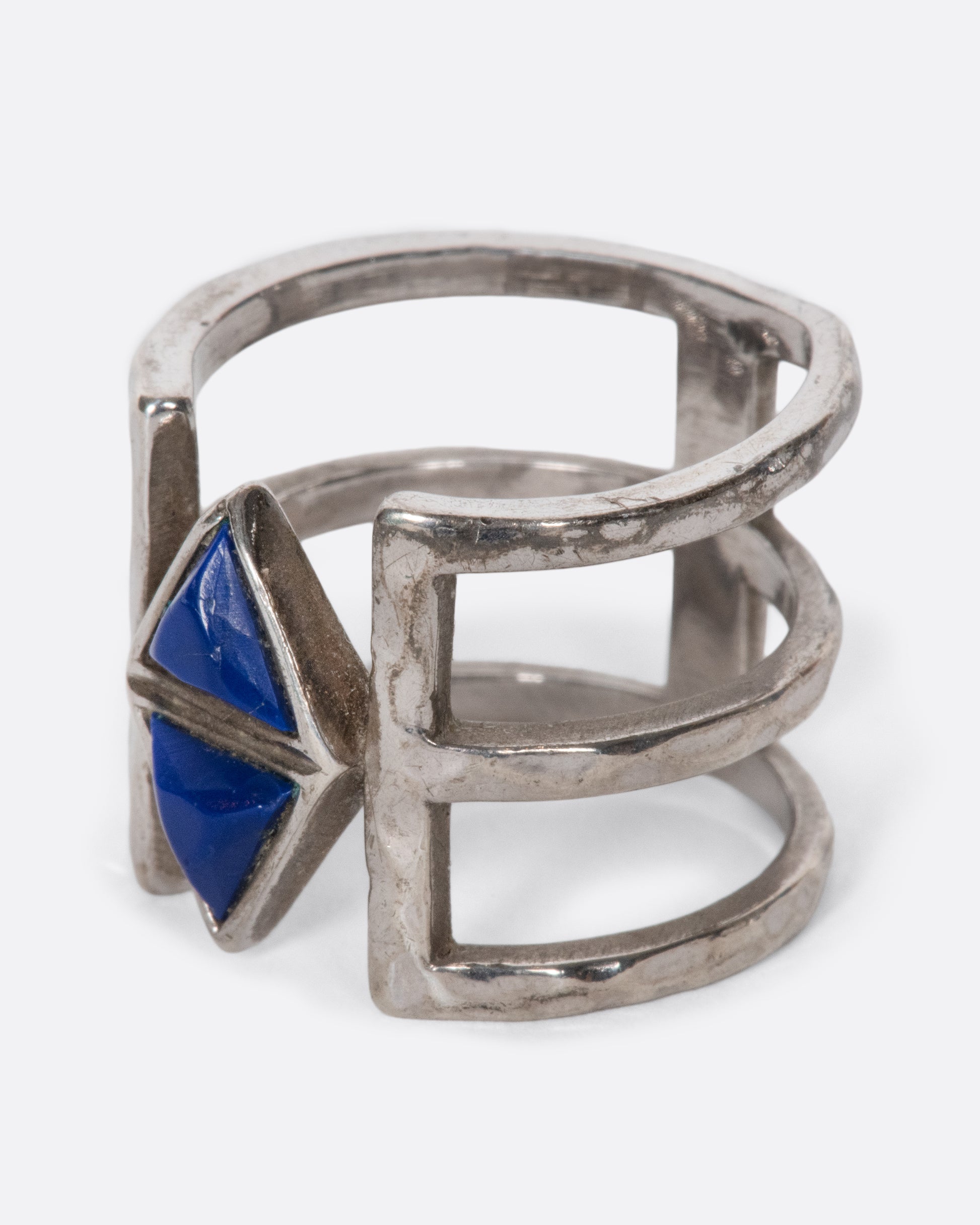 This triple-banded sterling silver vintage ring is centered around a pair of dreamy lapis triangles. Negative space between the bands gives the illusion that the lapis is effortlessly floating. This piece takes up a lot of space on your finger, creating an elongating effect.