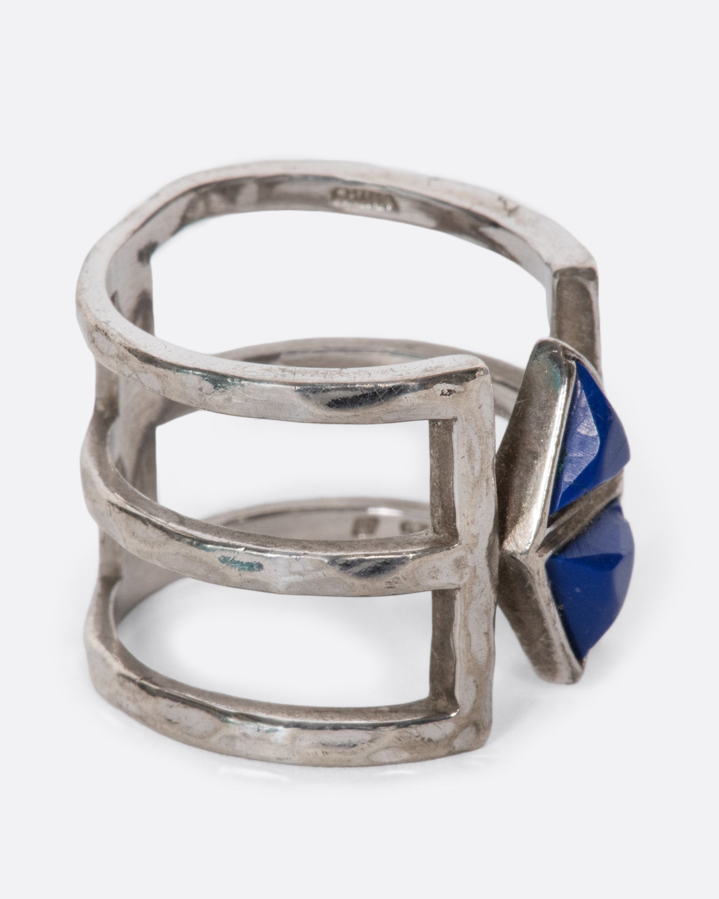 This triple-banded sterling silver vintage ring is centered around a pair of dreamy lapis triangles. Negative space between the bands gives the illusion that the lapis is effortlessly floating. This piece takes up a lot of space on your finger, creating an elongating effect.