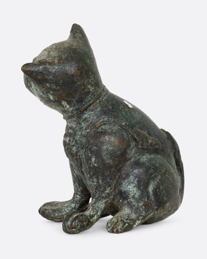 An antique cast iron dog, shown from the side.
