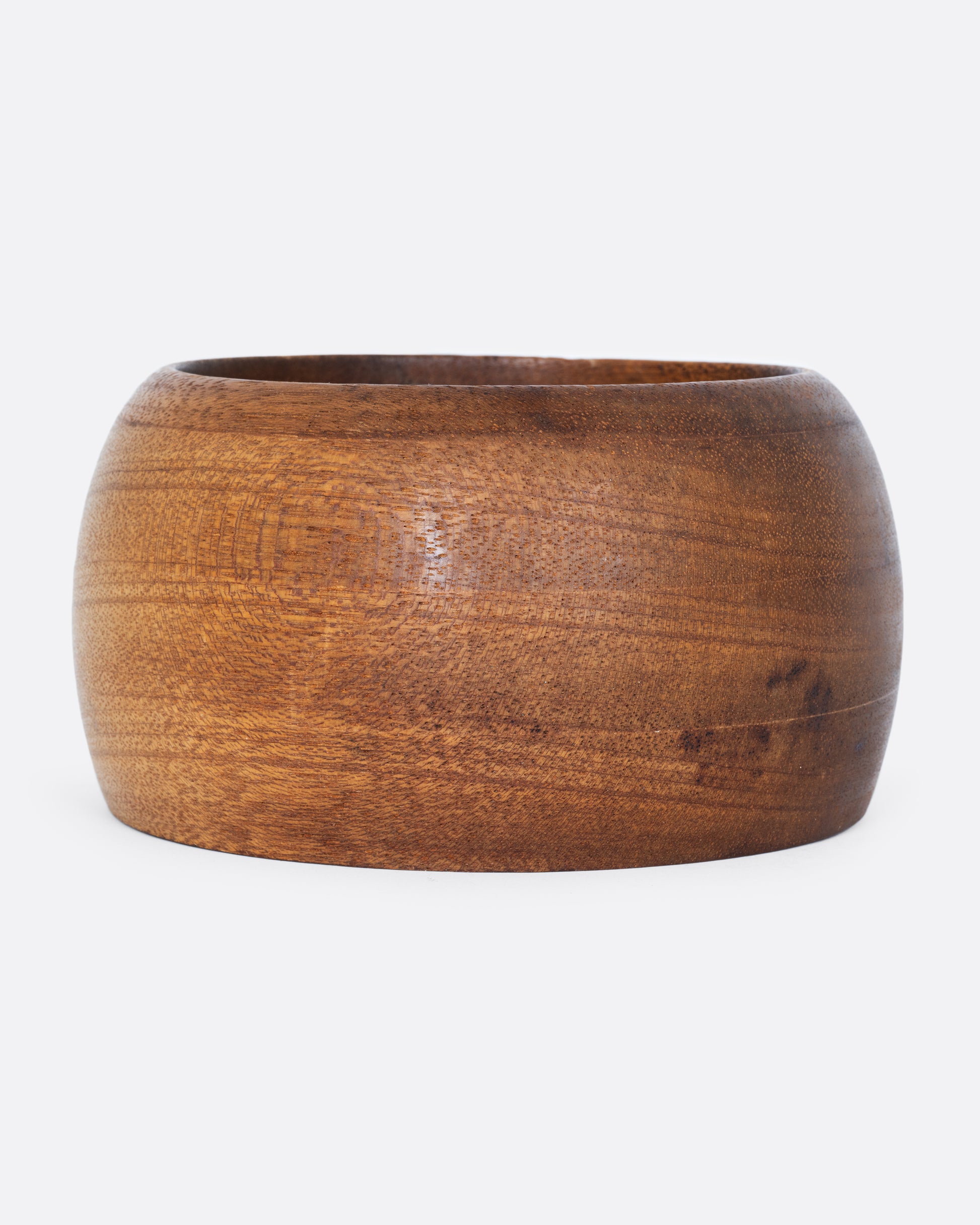A wooden bowl shown from the side.