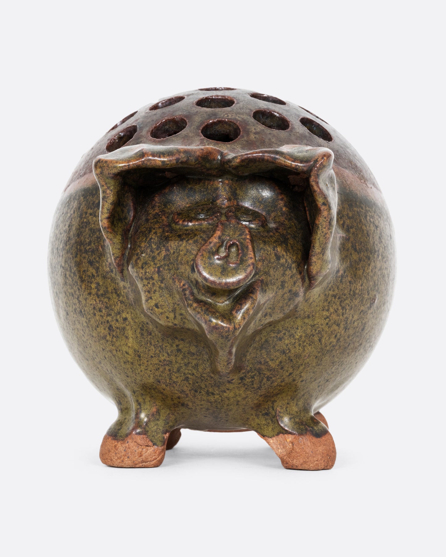 A green ceramic frog flower vase that's a pig! Shown from the front.