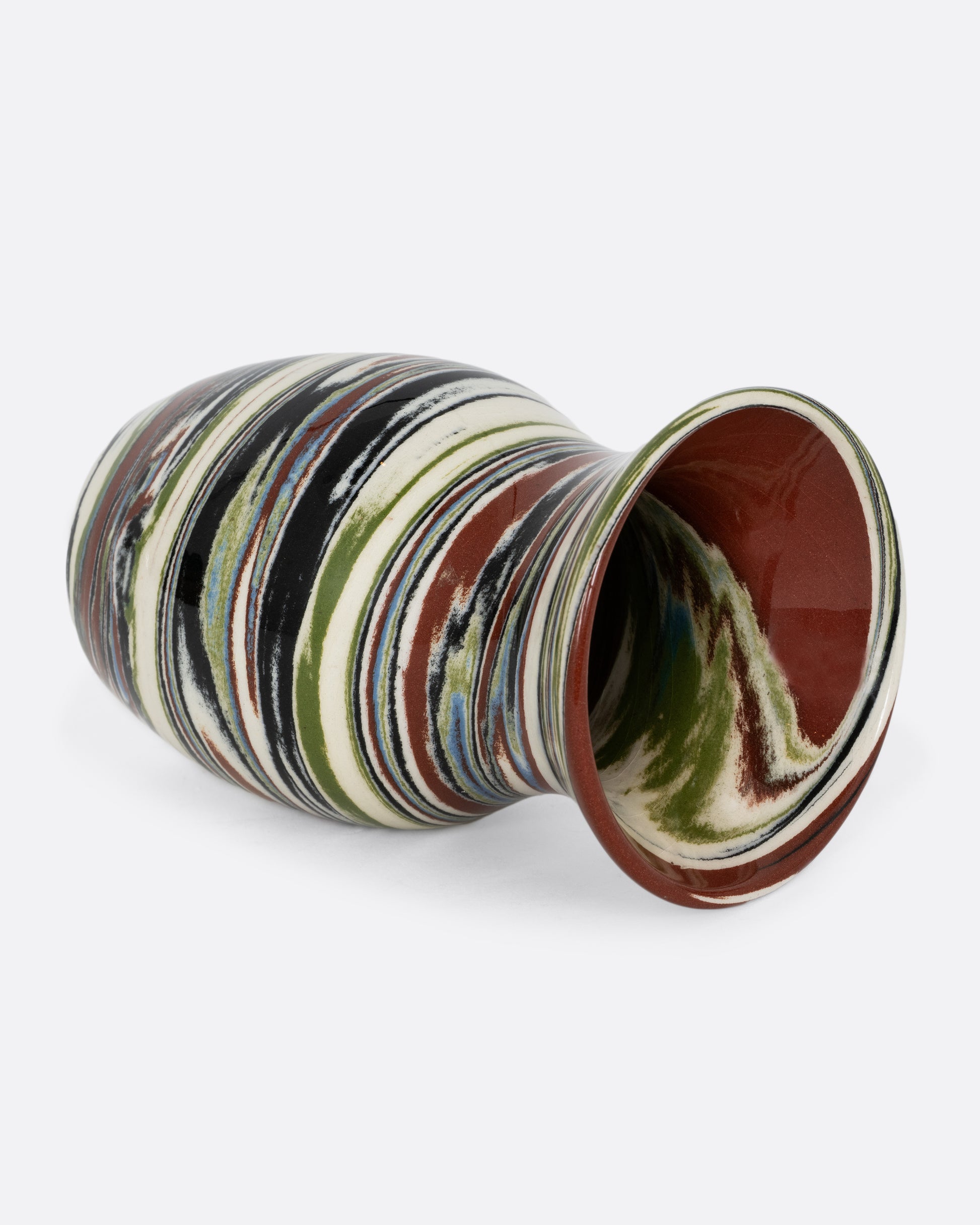 A multicolor earth tone swirled Nerikomi vase. Shown from the side.